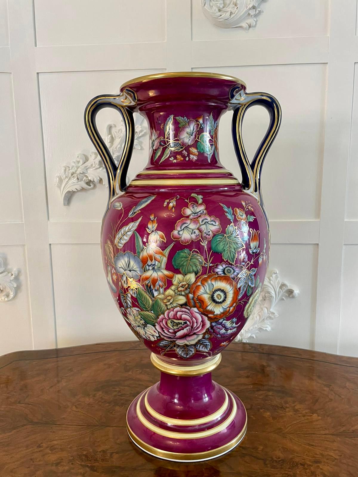 Exceptionally beautiful large Staffordshire porcelaneous twin handled vase being 57 cm high and raised on a pedestal shaft to a bulbous body and a trumpet shaped rim enclosed by two twin loop handles decorated with very attractive mauve background