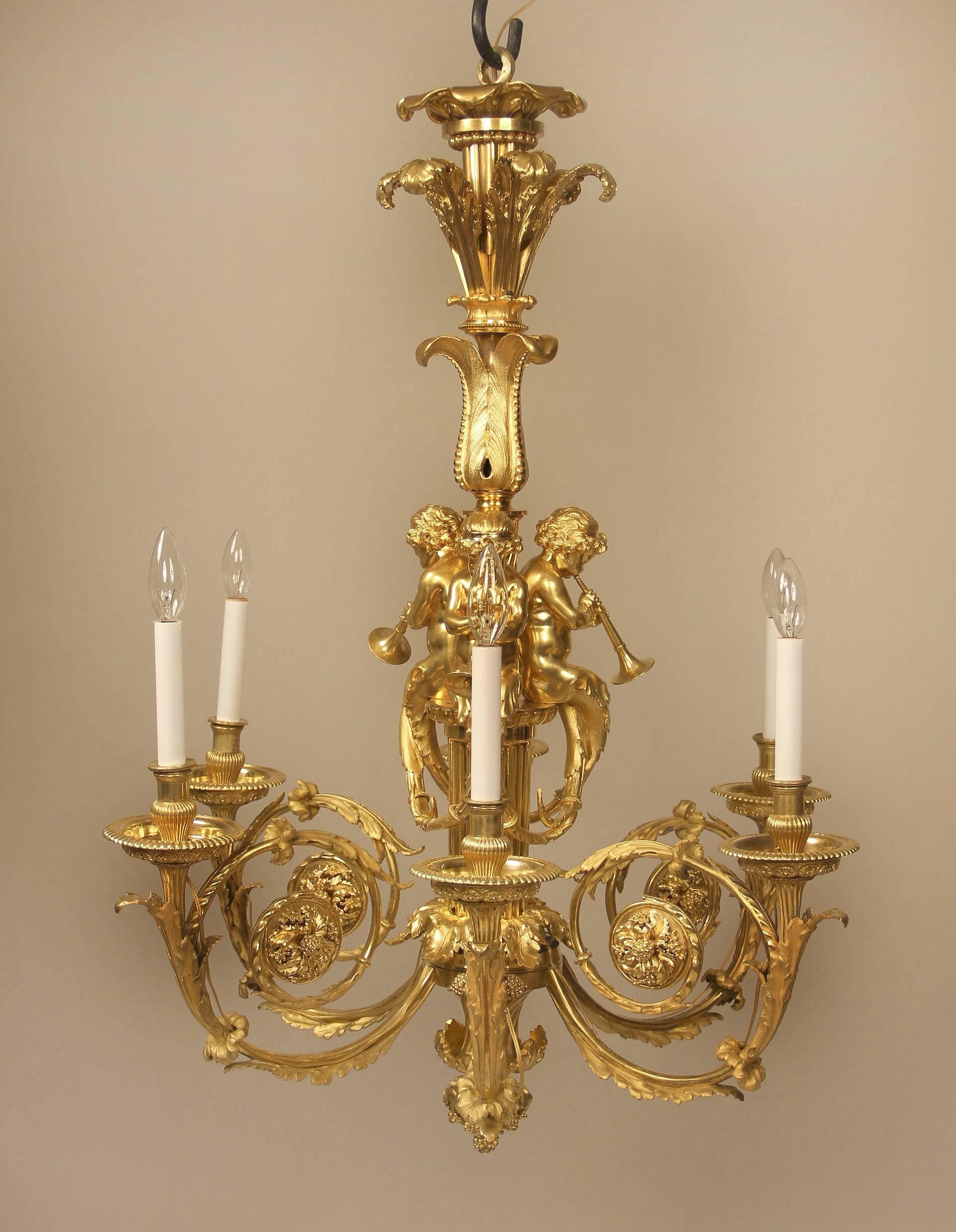 An exceptional late 19th century gilt bronze six-light chandelier

By Henry Dasson

With three large bronze cherubs playing horns, the neck with plumes, the base and arms with flowers, berries and foliage, six perimeter lights.

Signed Henry