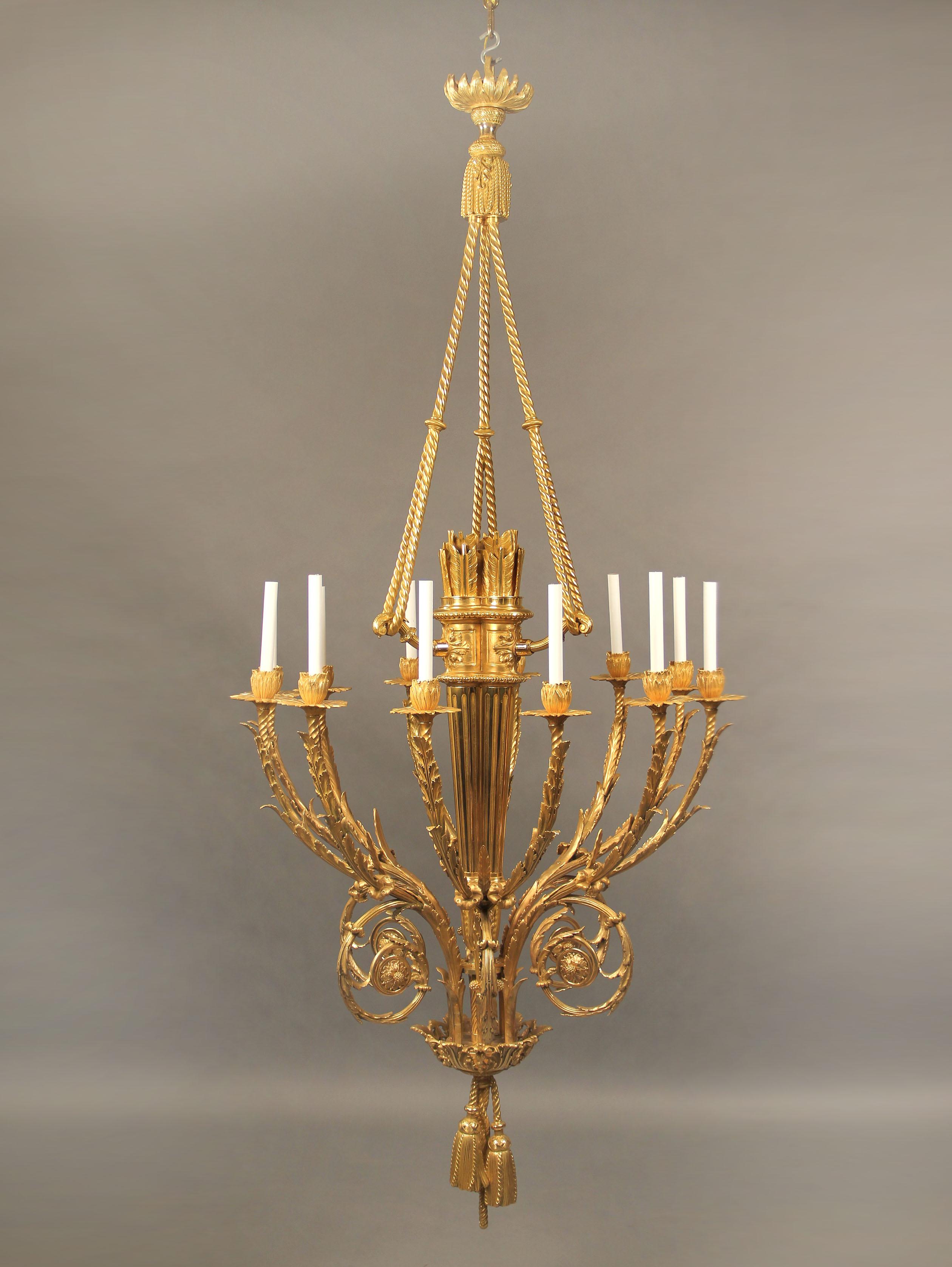 An exceptional late 19th century gilt bronze 12-light chandelier

A fluted tapering central body, 12 rope and foliate candelabrums, five foliate winding scrolls, the central body connected to the canopy by twisted rope and tassel, the chandelier