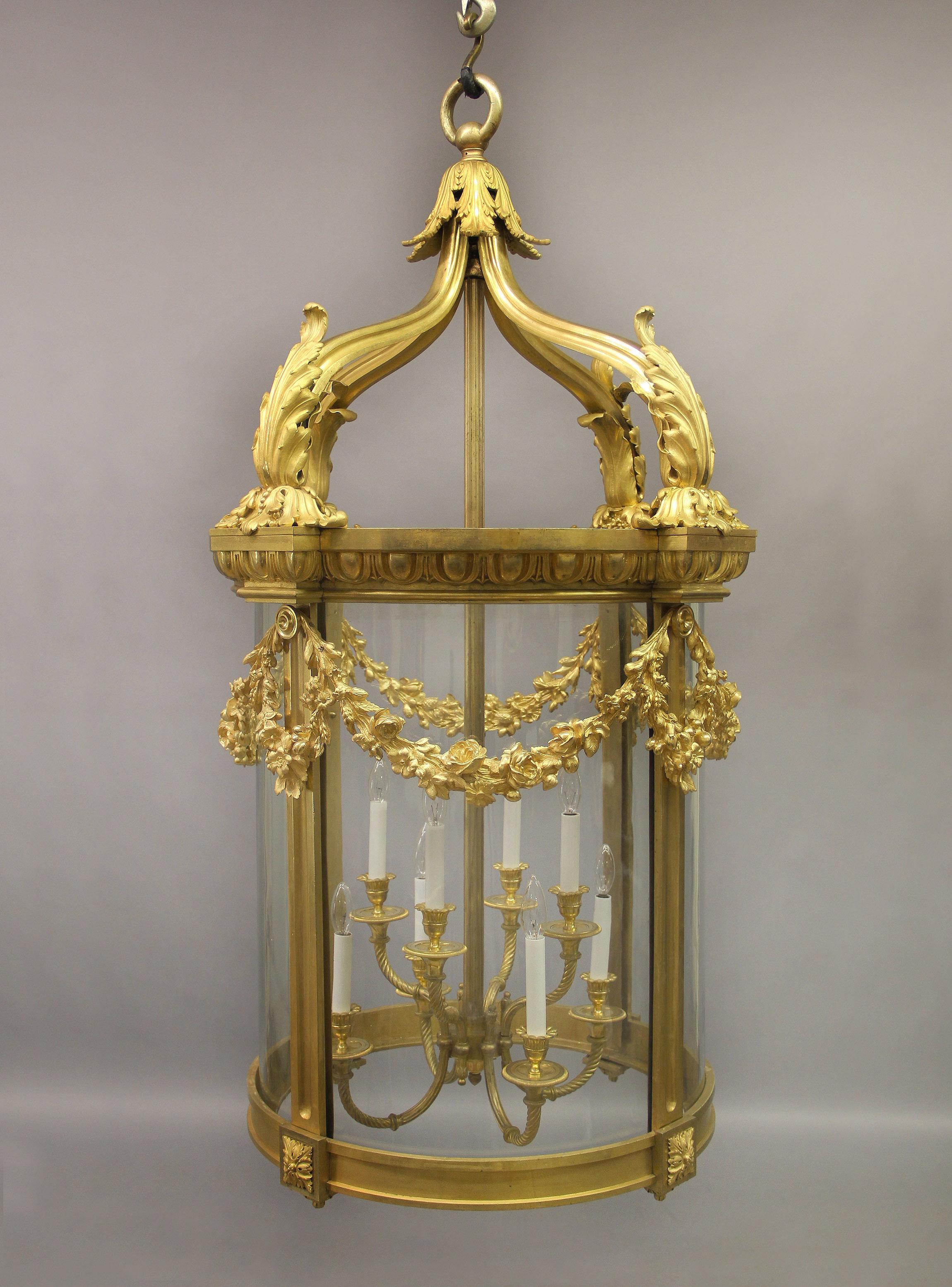 An exceptional late 19th century gilt bronze palatial eight light lantern

The large and important frame designed with a crowned top with acanthus leaves and berries, the body surrounded by wreaths and garlands with flowers and foliage that are