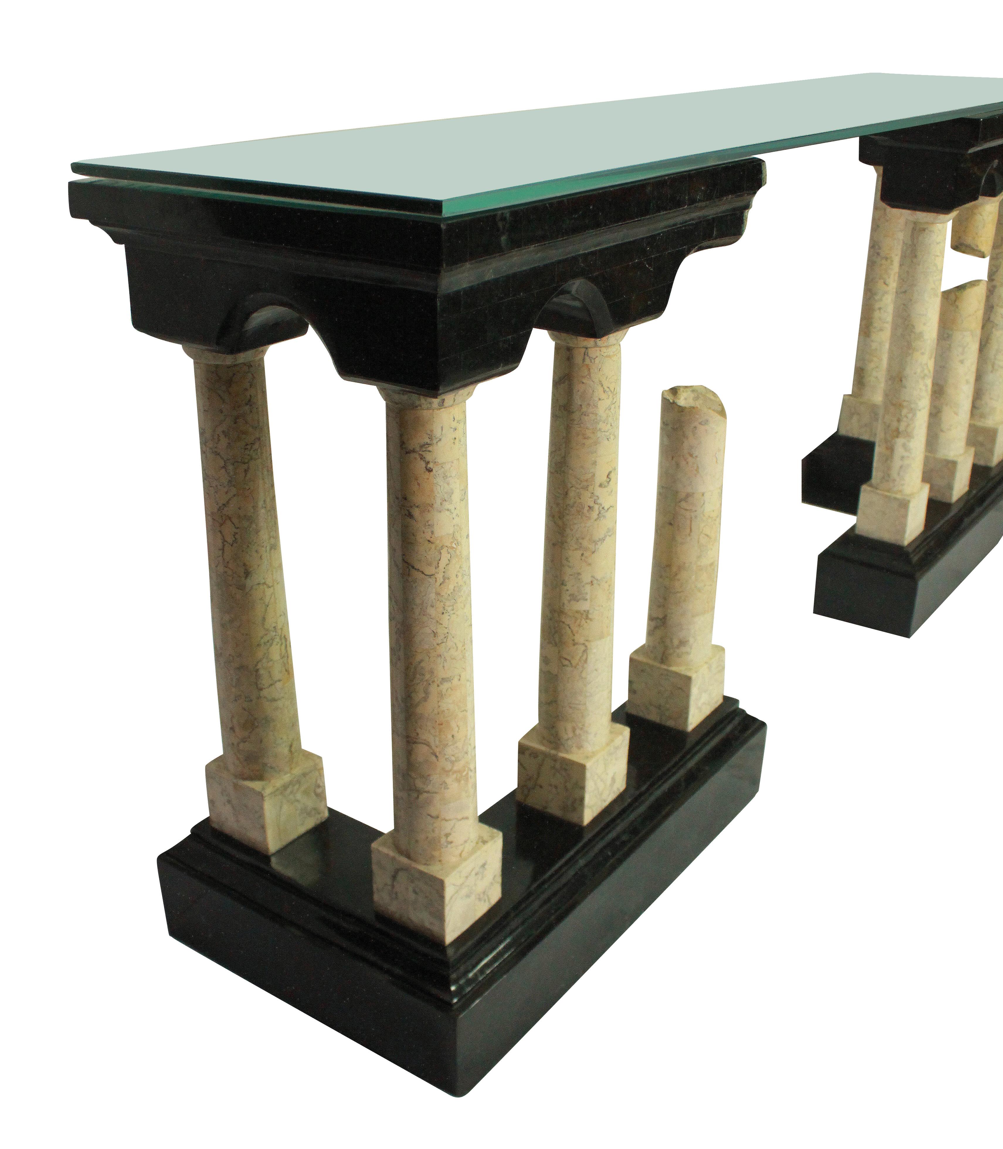 An exceptional Italian console table depicting ancient Roman ruins in polished marble veneers. The base and pediment in a very dark green, with ivory colored pillars. With a plate glass top.