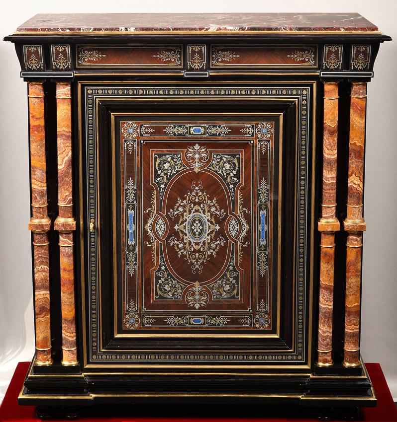 Blackened wood side-cabinet attributed to Susse Frères, opening with a central cupboard door underlined with gilt bronze rods, flanked by two small onyx columns encircled with bronze. With a very Fine and elaborate “Boulle” ornamentation inlaid with