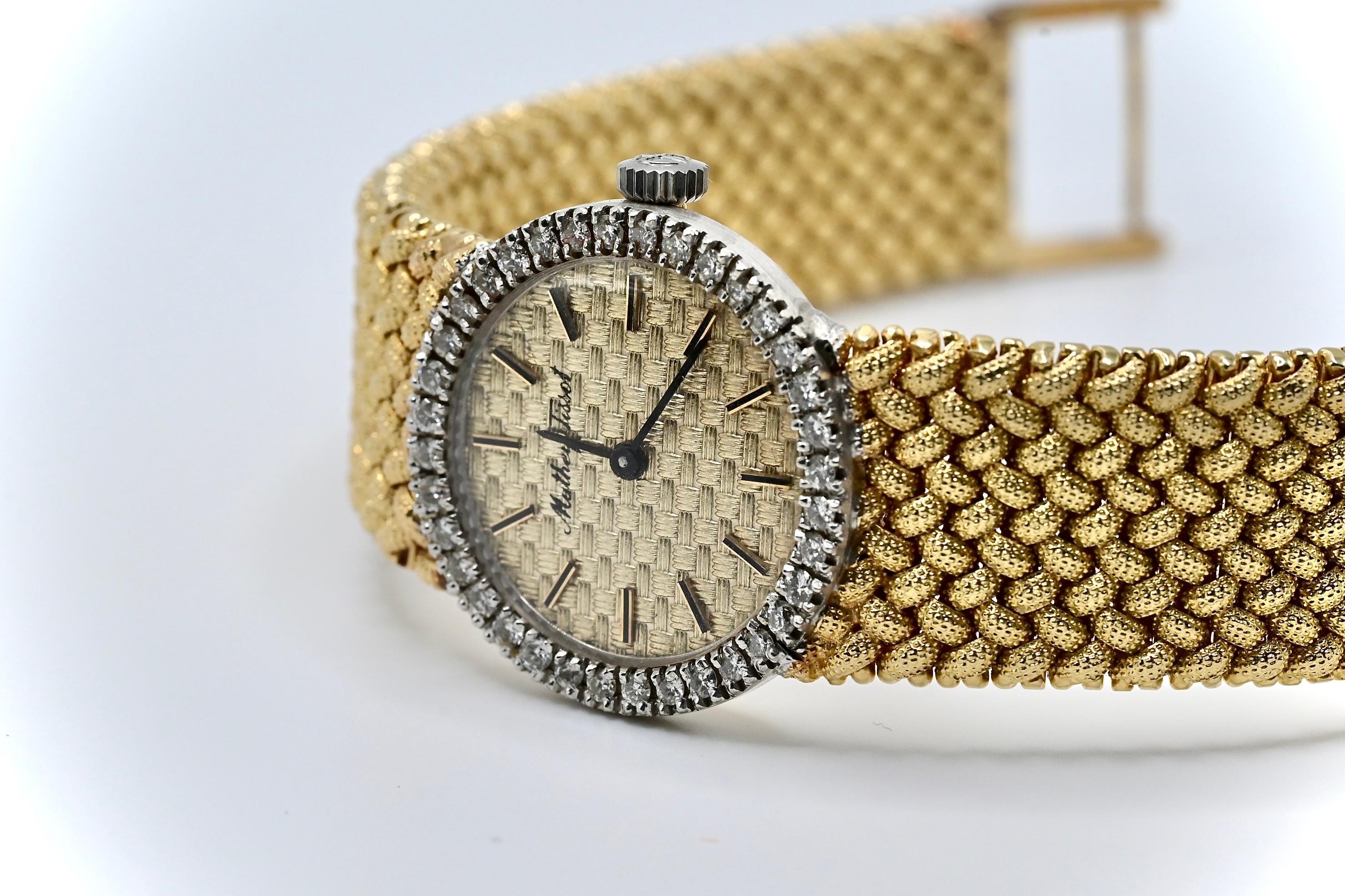 This is a gorgeous 14k yellow gold Mathey Tissot ladies wristwatch with 36 high quality round cut diamonds encrusted around the bezel. It weighs approximately 54 grams, the strap length is 7 1/8 inches, the diameter is 25mm, and It’s in great