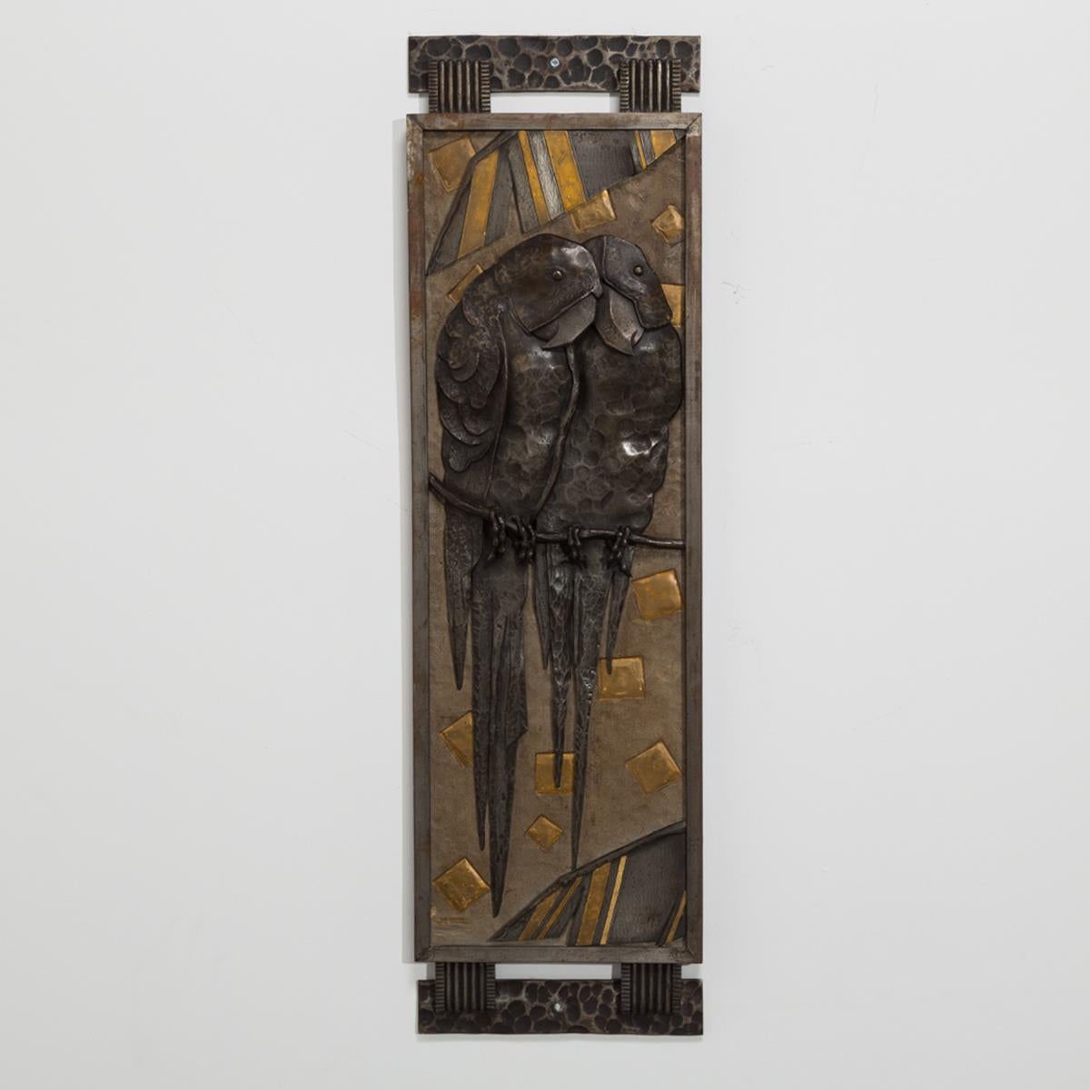 Exceptional mirror with sculpted and patinated steel parrot relief scene by Michel Zadounaisky, circa 1930 signed. 

Michel Zadounaisky (1903-1983) trained at the Beaux Arts of Lyon, France. His work includes entry grid in the Treasury Room of the