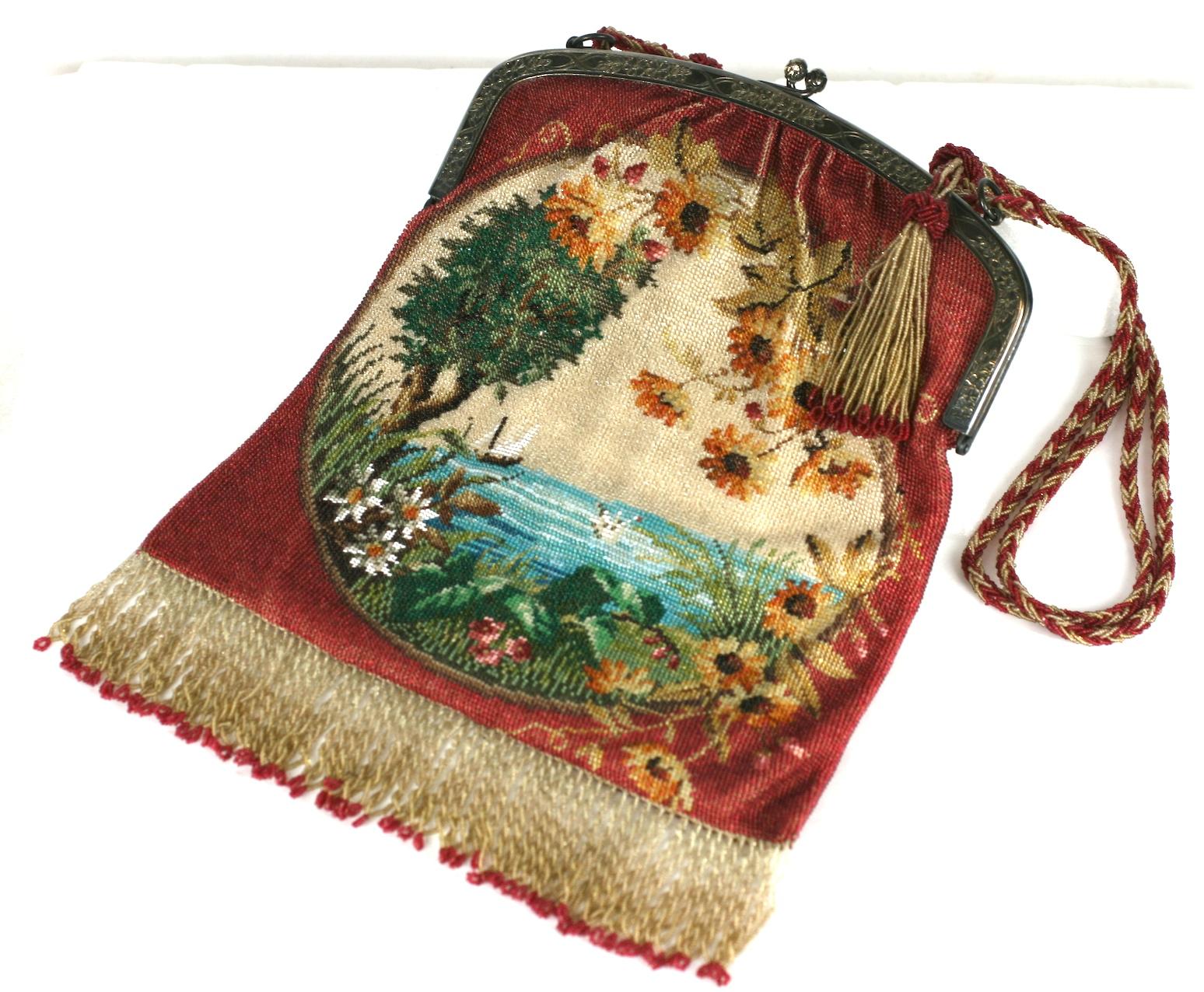 Exceptional and collectible Micro Beaded Bag from the early 20th Century with hand beaded and braided handle with tassels. Pictorial micro beading creates a vignette with sailing ships in a distant ocean scene. Daisies are falling down around the