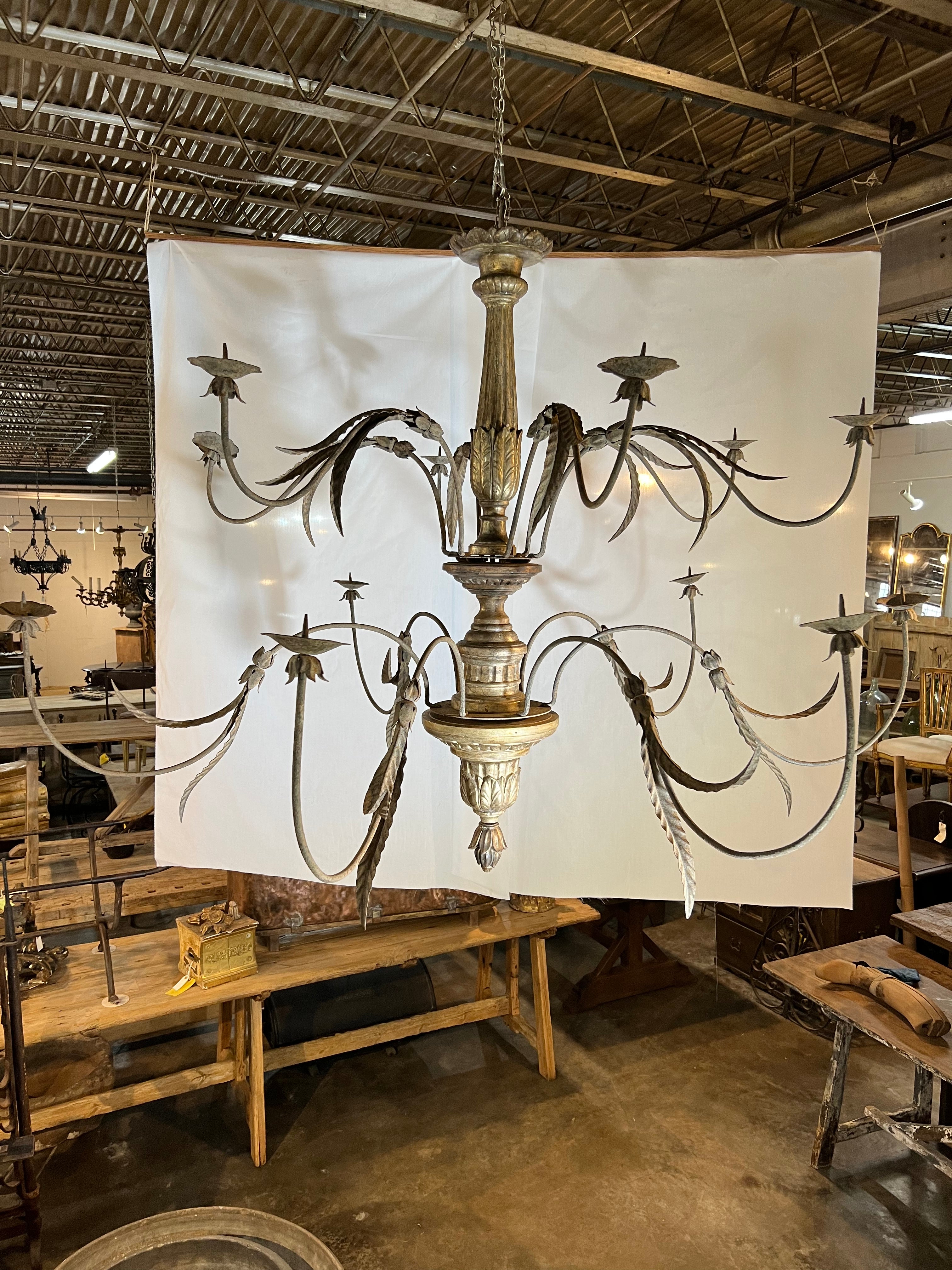 An outstanding and exceptional mid-18th century 2-Tiered Chandelier from Genoa, Italy, Beautifully constructed with a giltwood shaft and iron arms. The gilt technique is referred to as Mecca - mixing gold and silver gilt. The chandelier has 12 arms.