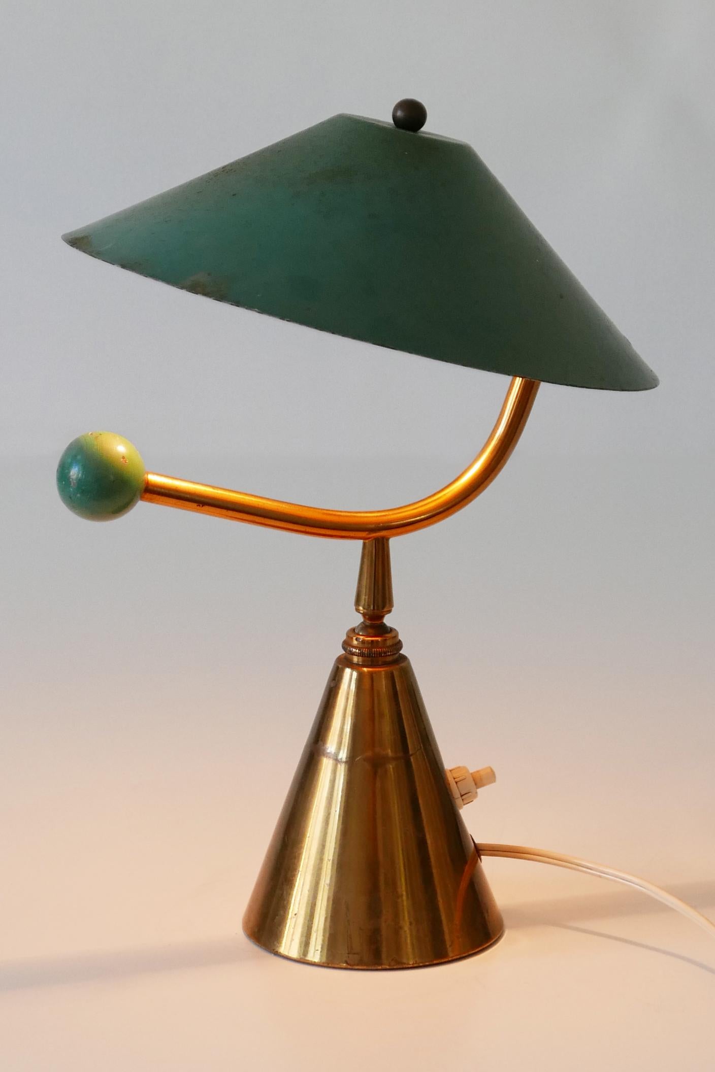 Extremely rare Mid-Century Modern table lamp. Designed and manufactured in 1950s, France. 
Due to the joint ball, the lamp shade is adjustable in various position.

Executed in brass, the lamp needs 1 x B22 bayonet bulb holder, is wired and in