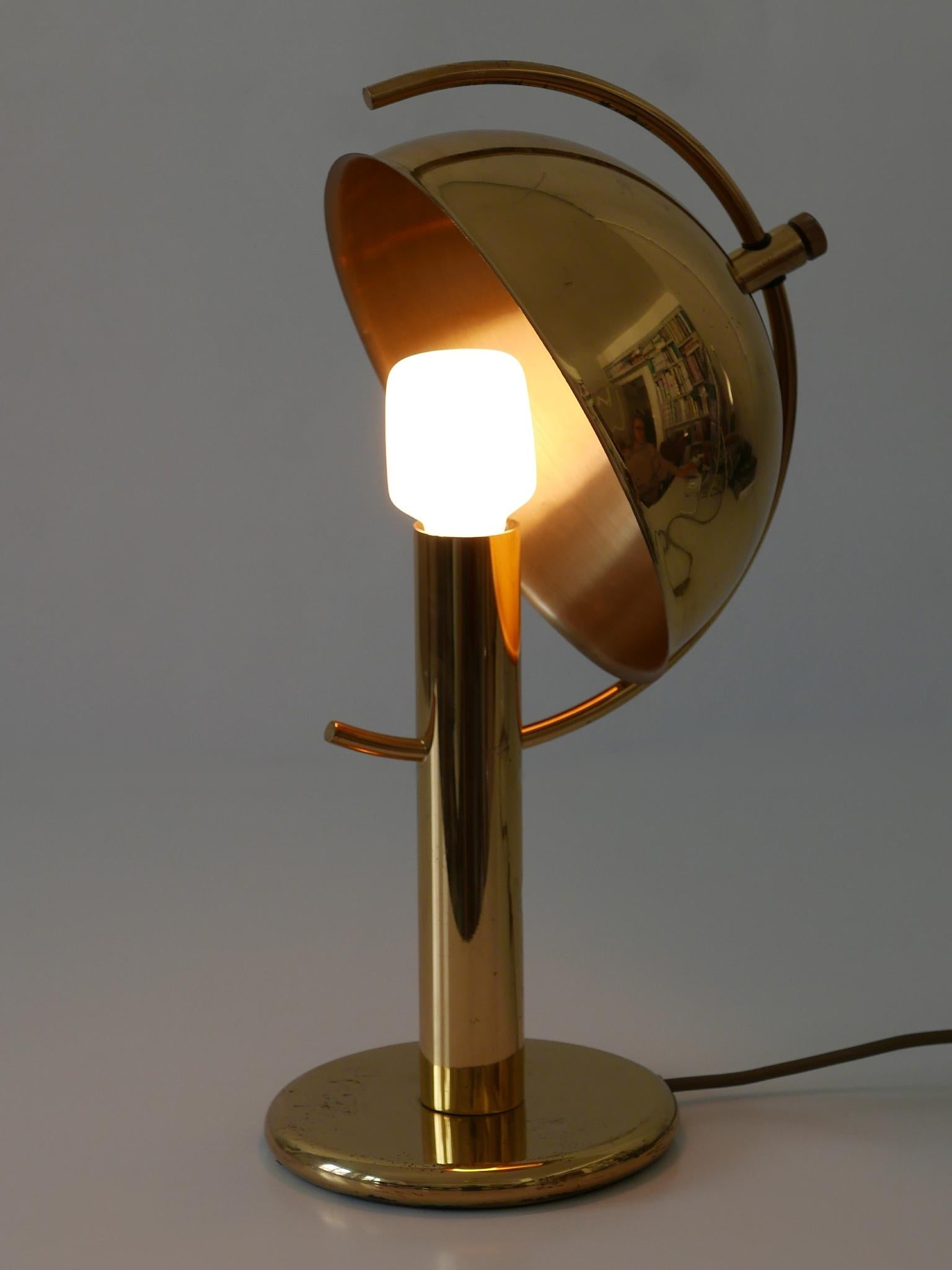 Exceptional and elegant Mid-Century Modern brass table lamp with adjustable lamp shade. Designed and manufactured by Gebrüder Cosack, Germany, 1960s.

Executed in massive brass sheet and tube, the lamp comes with 1 x E27 / E26 Edison screw fit