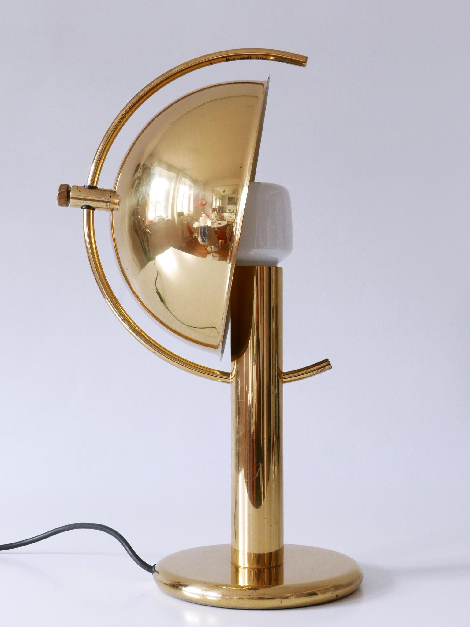 Exceptional, elegant and highly decorative Mid-Century Modern brass table lamp with adjustable lamp shade. Designed and manufactured by Gebrüder Cosack, Germany, 1960s.

Executed in massive brass sheet and tube, the lamp comes with 1 x E27 / E26