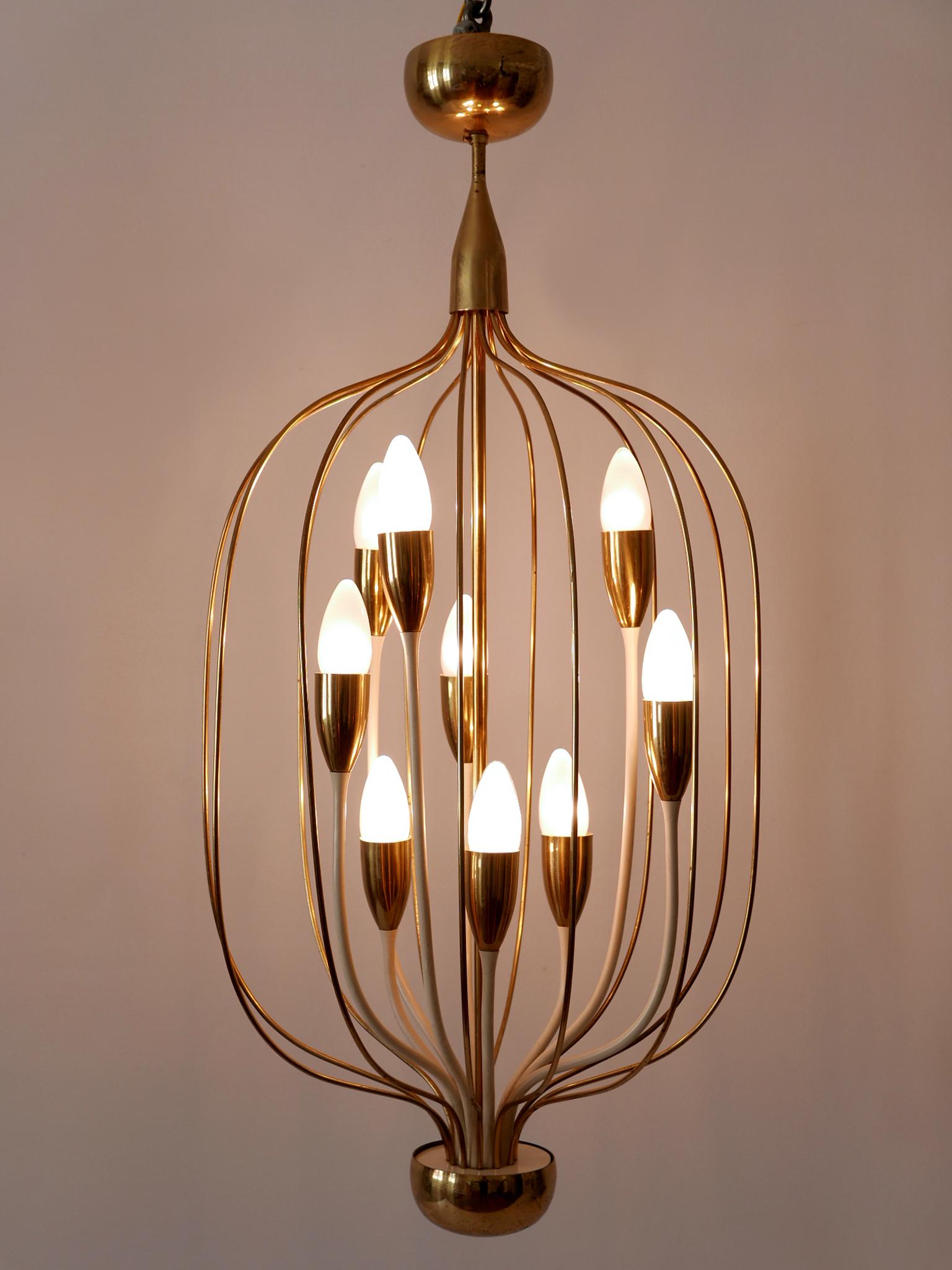 Extremely rare, lovely and highly decorative Mid-Century Modern nine-flamed pendant lamp or chandelier. Designed and manufactured probably in Germany, 1950s.

Executed in brass, the pendant lamp / chandelier comes with 9 x E14 / E12 Edison screw fit