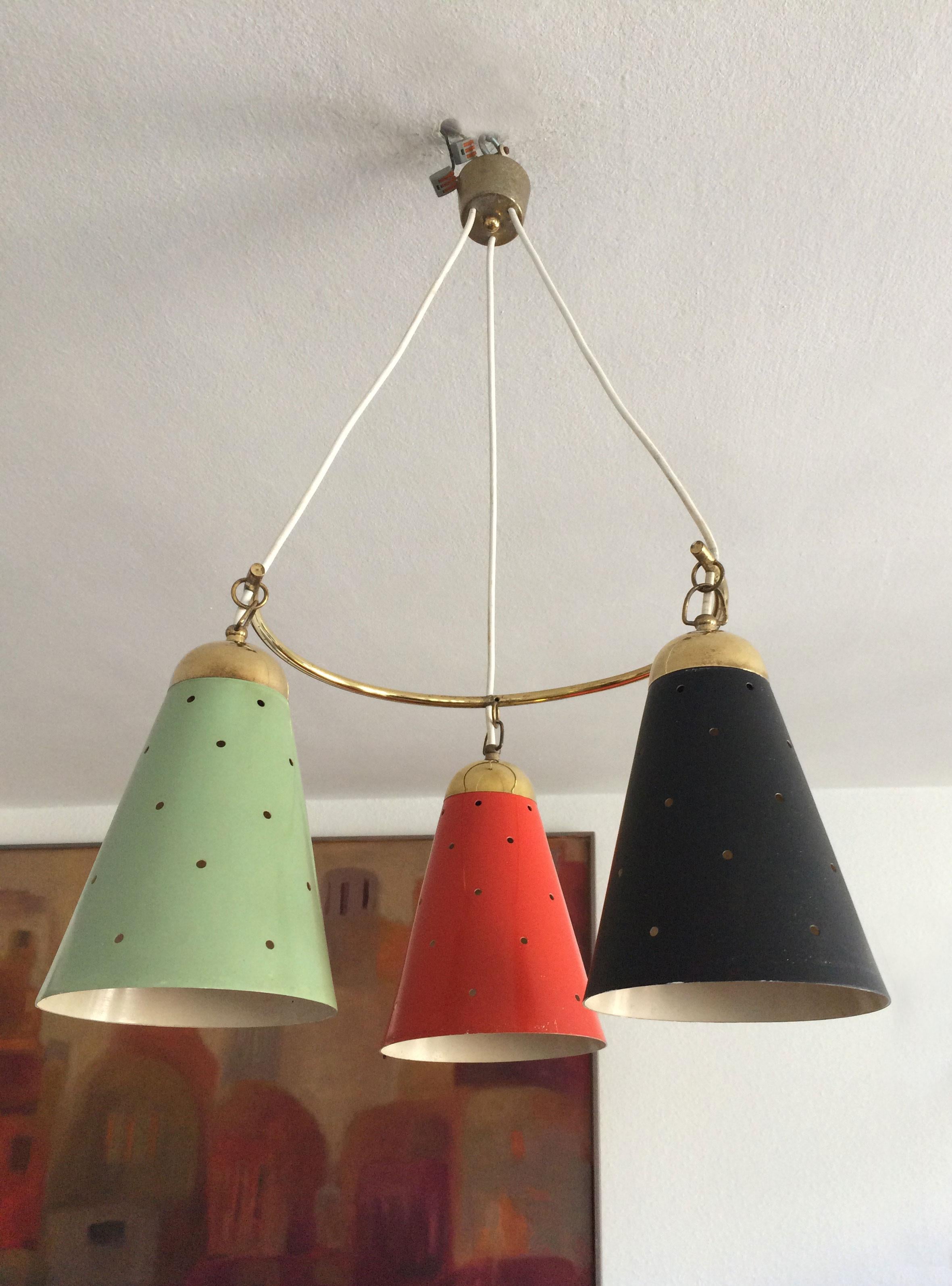 Gorgeous Mid-Century modern pendant lamp with three colored and perforated metal shades. Designed and manufactured in 1950, Germany. The lamp needs 3 x E27 Edison screw fit bulbs.

Executed in green, red and black lacquered, perforated aluminium