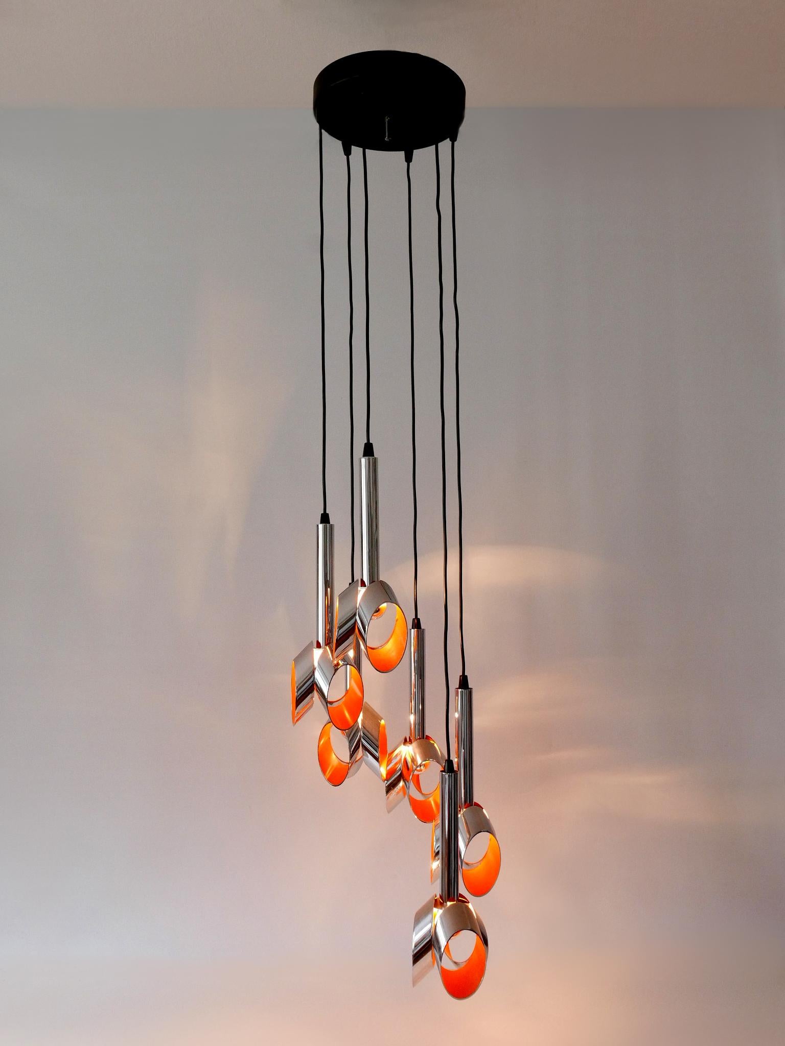 Extremely rare, lovely and highly decorative Mid-Century Modern six-armed tulip chandelier or pendant lamp. Designed and manufactured probably by RAAK, the Netherlands, 1970s.

Executed in chrome-plated and enameled metal, the chandelier comes