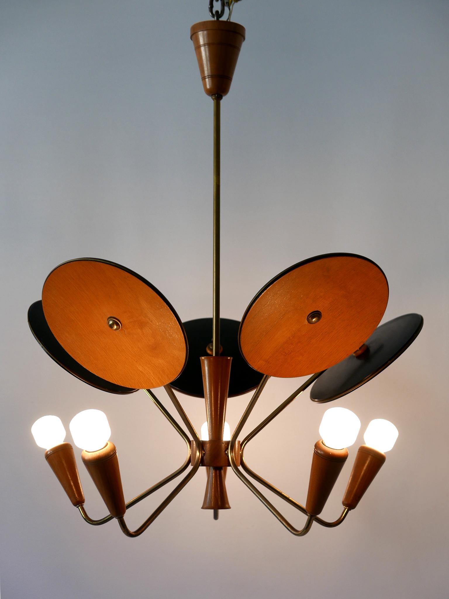 Extremely rare and highly decorative Mid-Century Modern five-armed sputnik chandelier or pendant lamp. Designed and manufactured probably in Germany, 1950s.

Executed in wood and brass, the lamp needs 5 x E14 / E12 Edison screw fit bulbs. It is