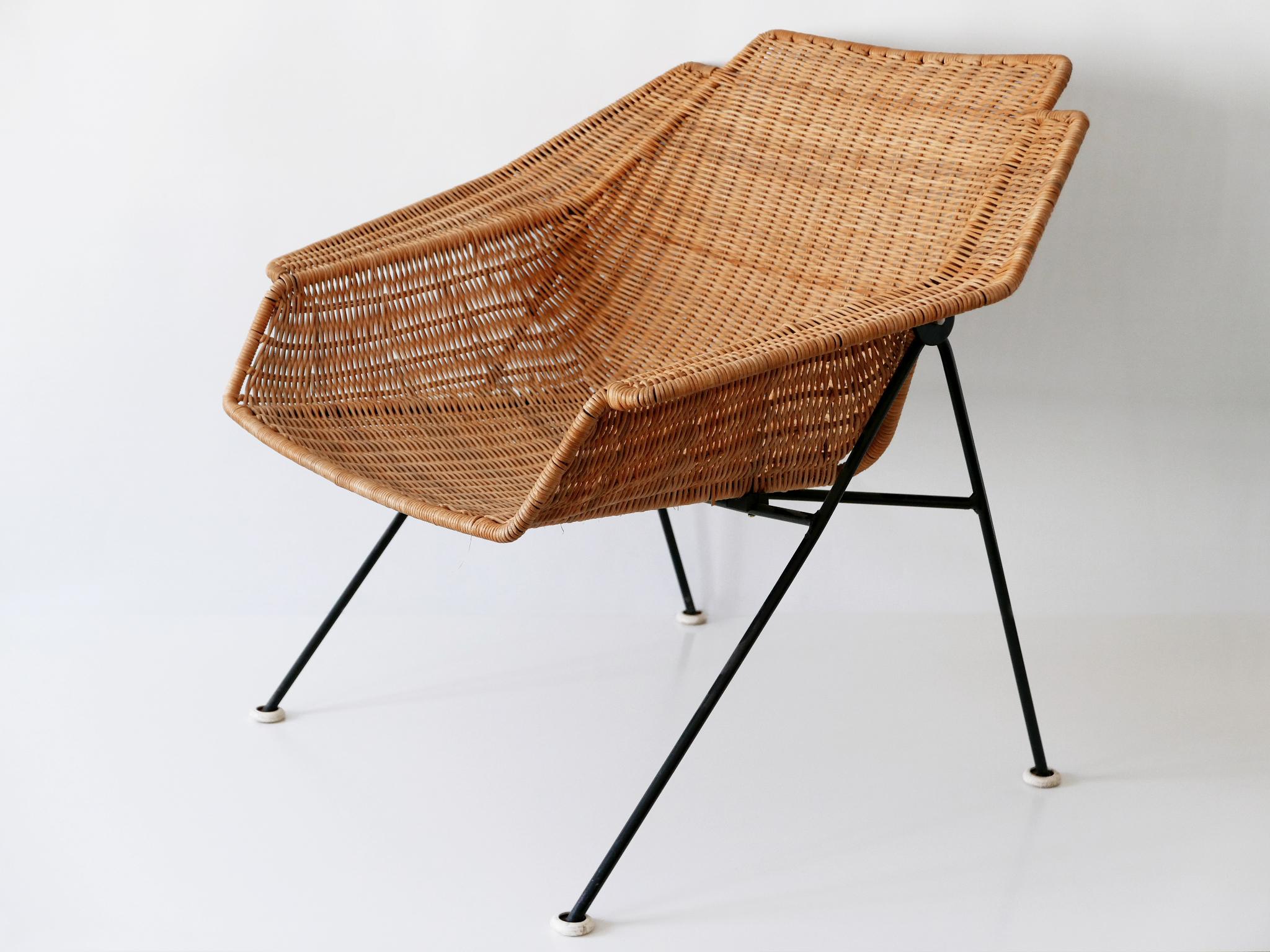 Extremely rare, large and decorative Mid-Century Modern wicker lounge chair or armchair. Designed and manufactured probably in 1950s, Sweden.

The chair is executed in wicker and metal. 

Good vintage condition. Wear consistent with use and age.