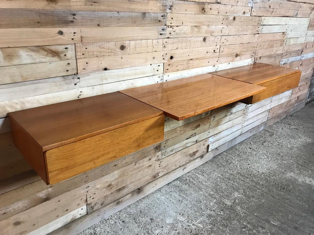 Totally free-hanging large teak 1960 retro desk, super minimalistic. It has a large desk and two cupboards. Height can be adjusted as required, it is very easy to fix to the wall (with metal or wooden wall brackets which are all included!).

We have