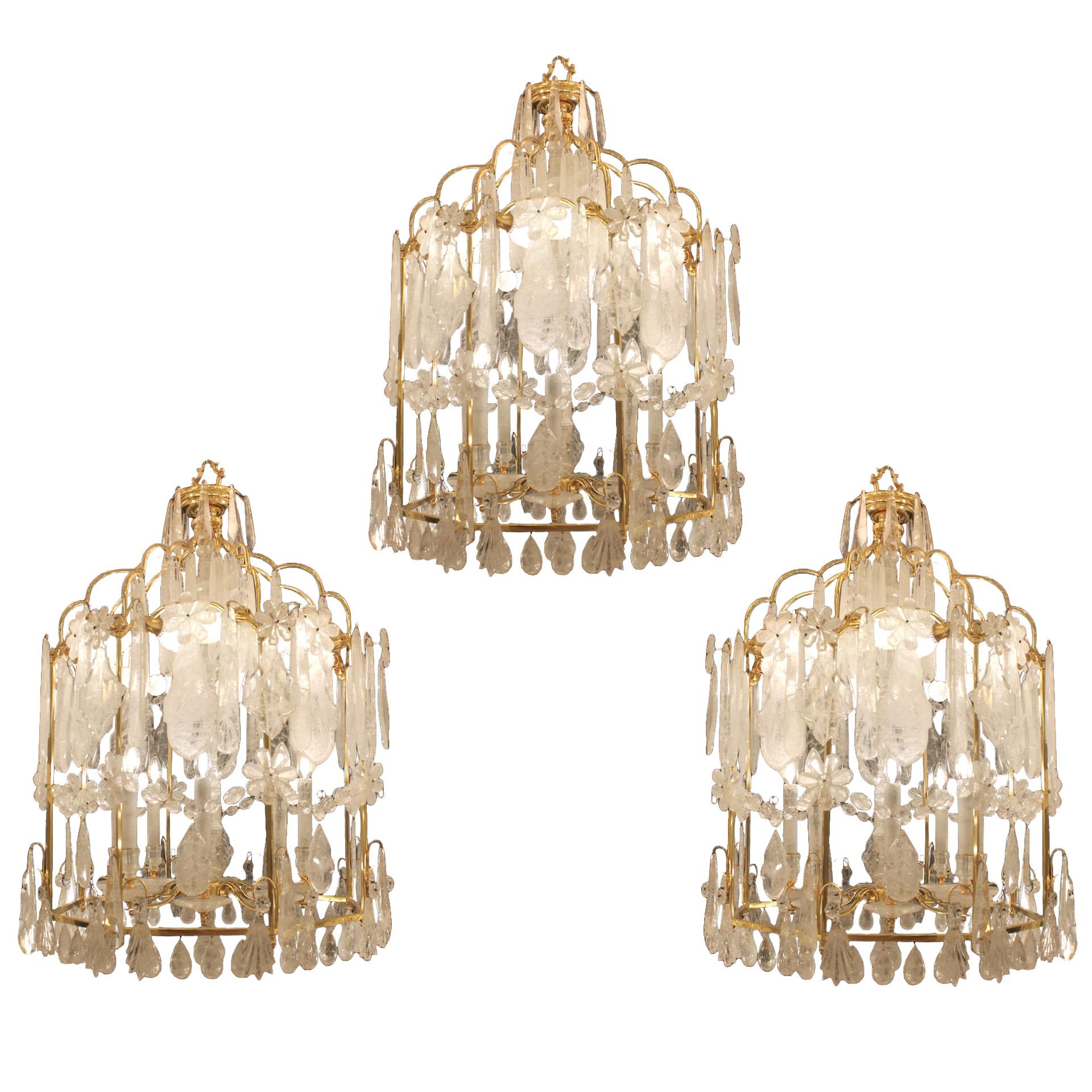 A trio of Rock Crystal Lanterns
Exceptional modern rock crystal lanterns, brass frame in a pure French 19th century style. Dressed with rock crystal flowers, plaques and drops and festooned with beads. The shaft of the frame is covered in rock