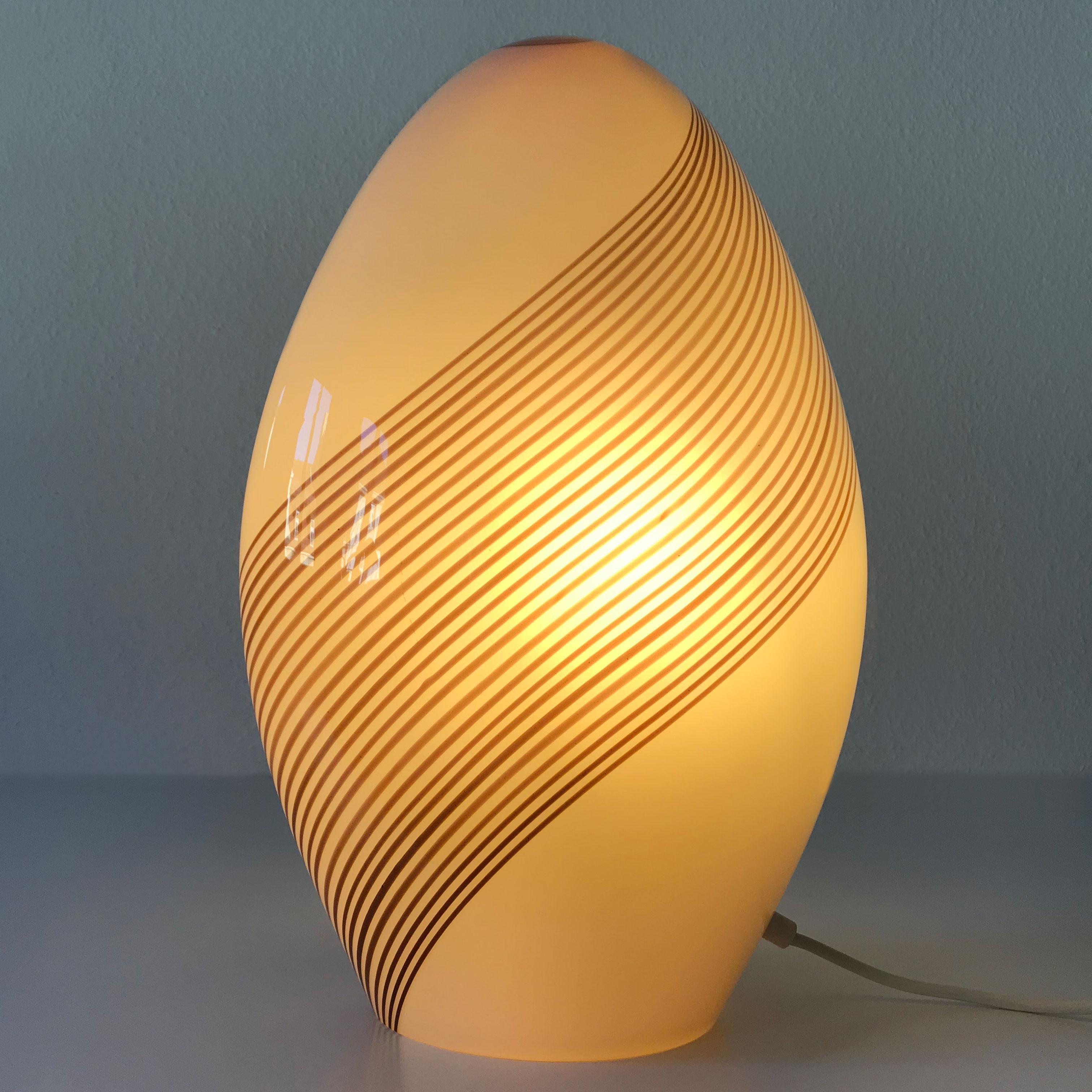 Extremely rare, large Mid-Century Modern Murano glass table lamp. Designed by Lino Tagliapietra for Effetre International Company, Italy, 1980s.

This table lamp is executed in thick Murano glass and needs an Edison screw fit E27 bulb. The lamp is