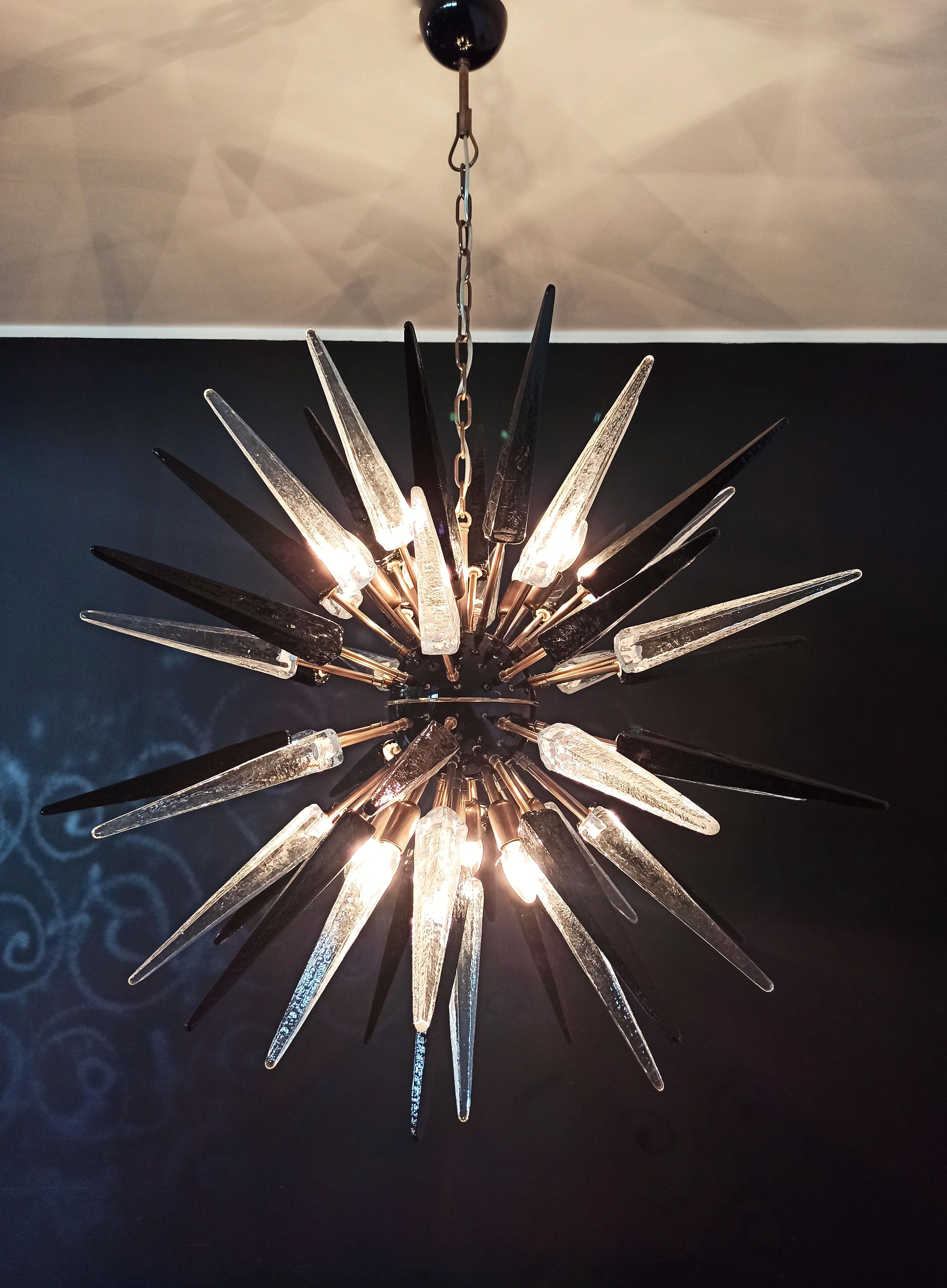
Italian Sputnik chandelier in a black and brass metal, 51 unobtainable trasparent and black glass tips. Murano blown glass in a traditional way. 10 light points.
Period: late xx century
Dimensions: 55,10 inches (140 cm) height with chain; 37,40