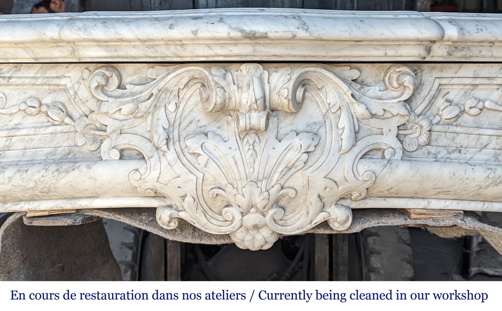 Exceptional Napoleon III period mantel in veined Carrara marble, adorned with a rich décor of palmettes and arabesques.

This fireplace is sold with a modern cast iron insert adapted to this fireplace but without any marble floor. This one could be