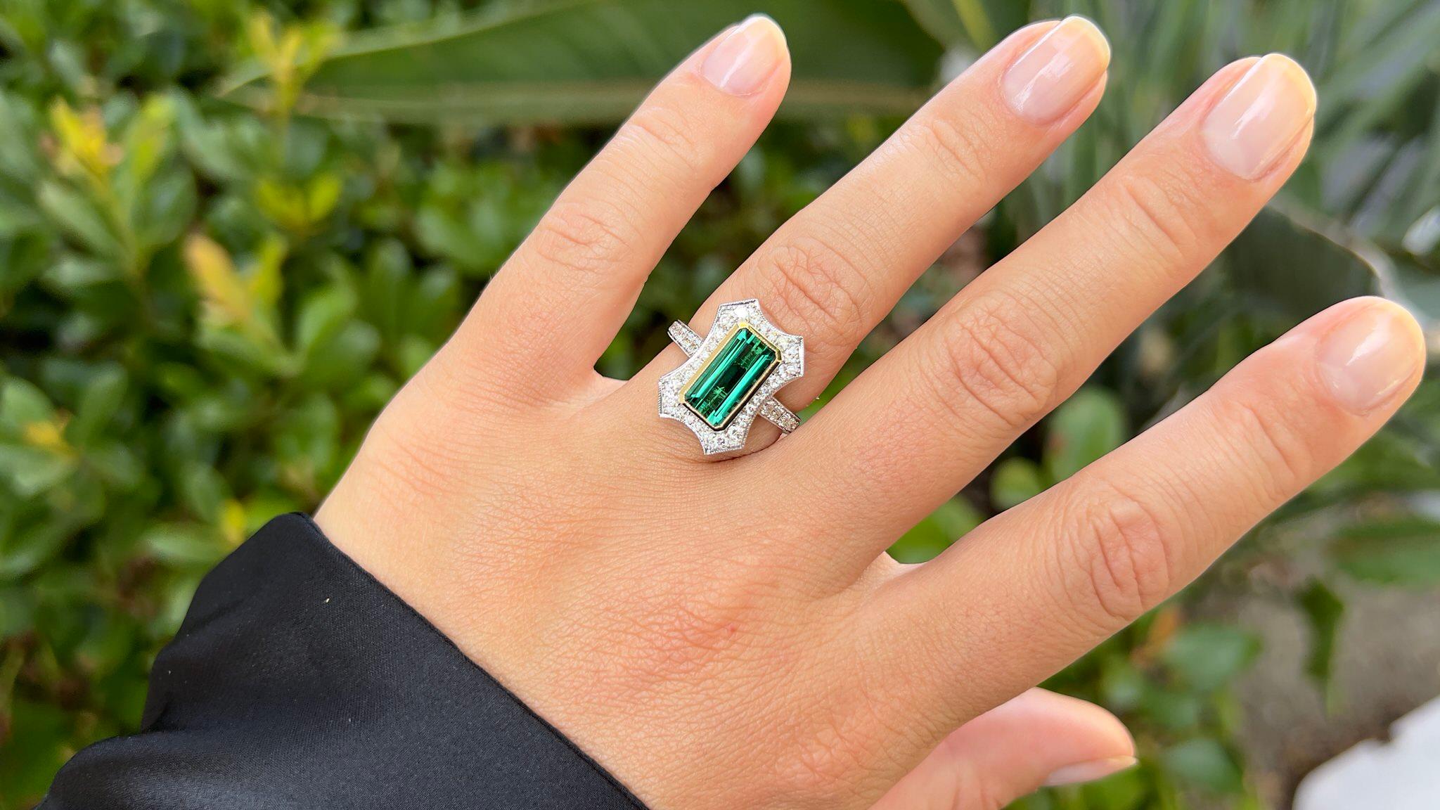 It comes with the Gemological Appraisal by GIA GG/AJP
All Gemstones are Natural
Green Tourmaline = 2.82 Carat
Quality: Exceptional, Clarity: Flawless, Cut: Emerald
38 Diamonds = 0.60 Carats
Cut: Round, Color: F-G, Clarity: VS
Metal: 14K Gold
Ring