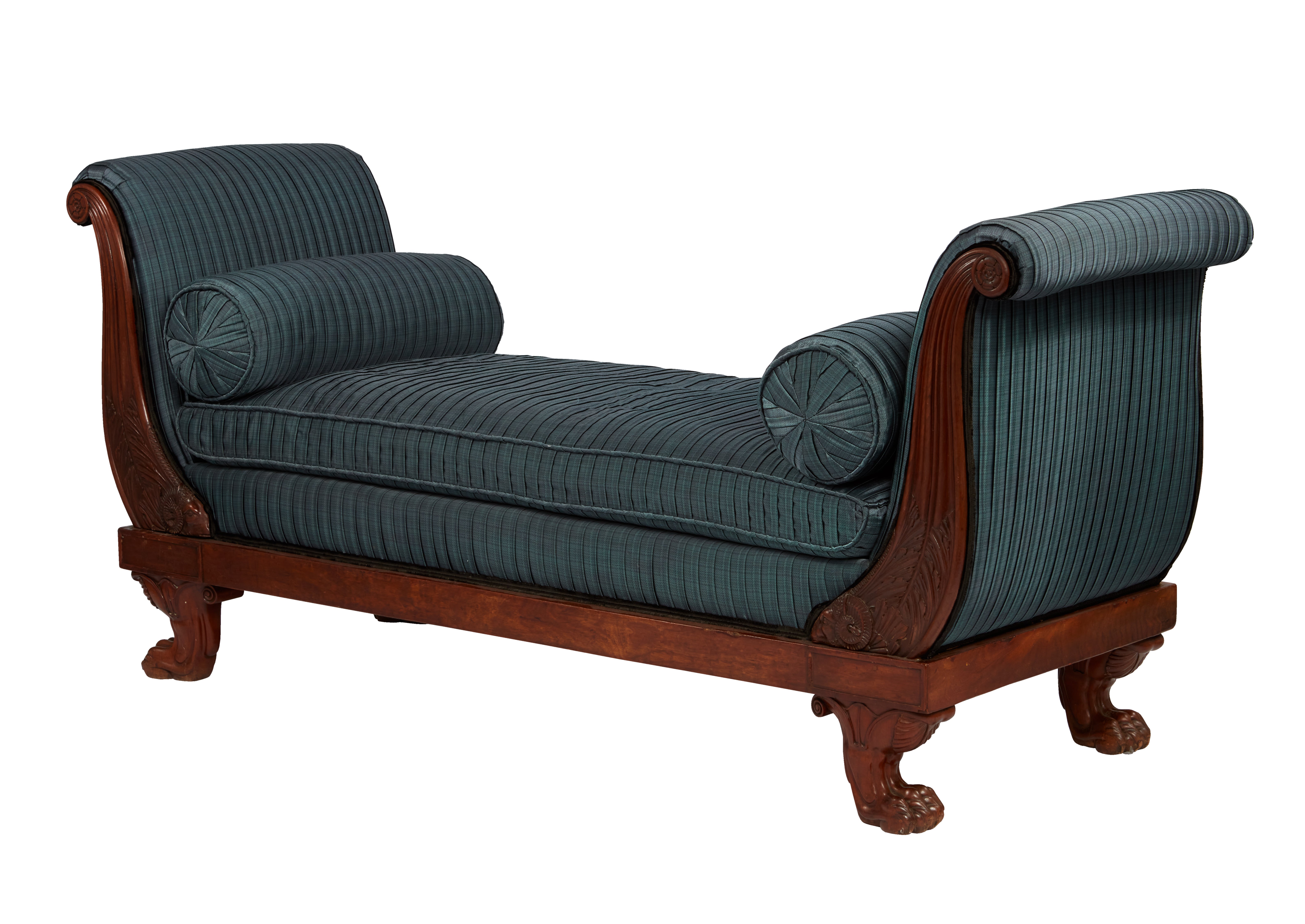 Finished on front and back, having solid mahogany scrolled ends with intricately carved acanthus leaves flowing up from a rams head base. The upholstered interior with Larsen pleated fabric over a flame mahogany frieze. The whole supported by