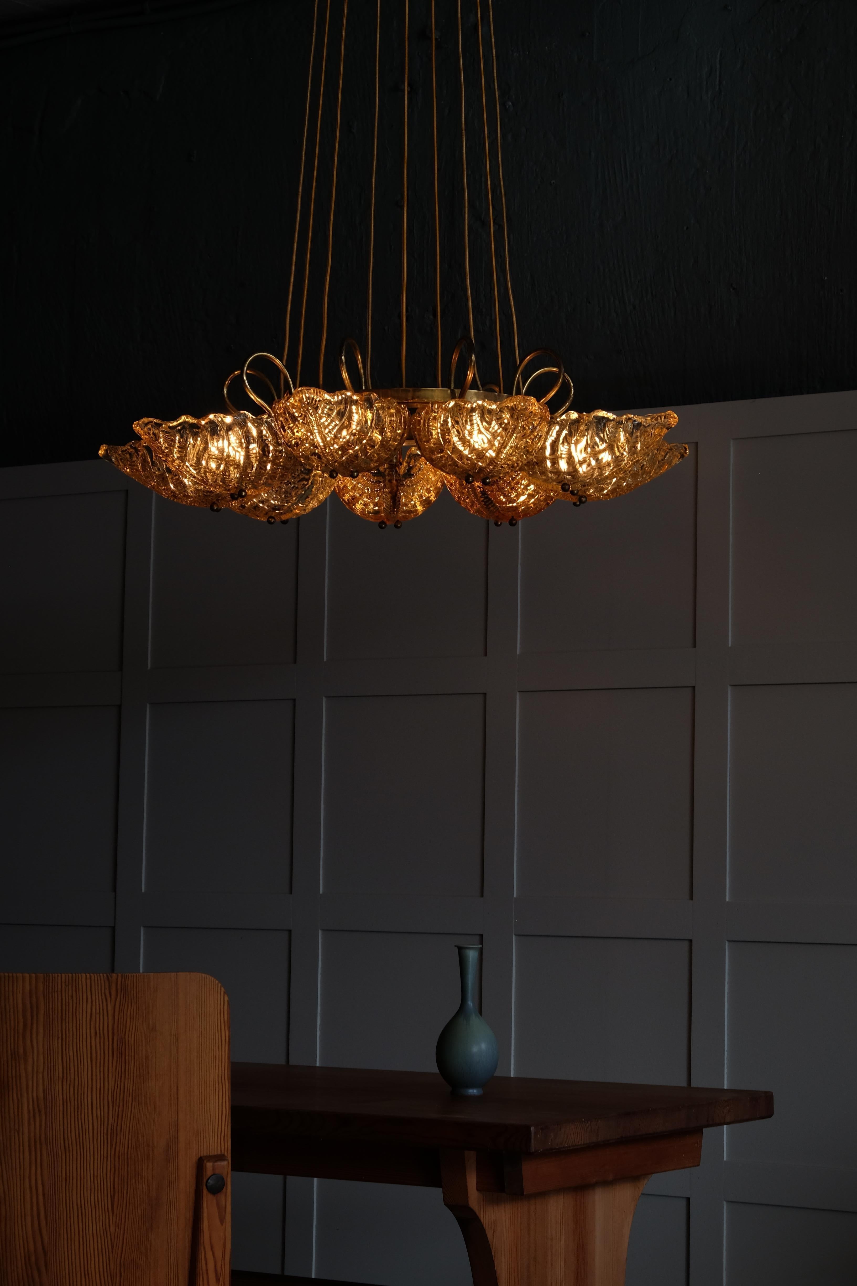 Extremely rare Orrefors glass and brass chandelier designed by Fritz Kurz, 1946, Sweden.
Excellent vintage condition, new wiring. 
Measures: Diameter 90 cm
Height 140 cm (adjustable).