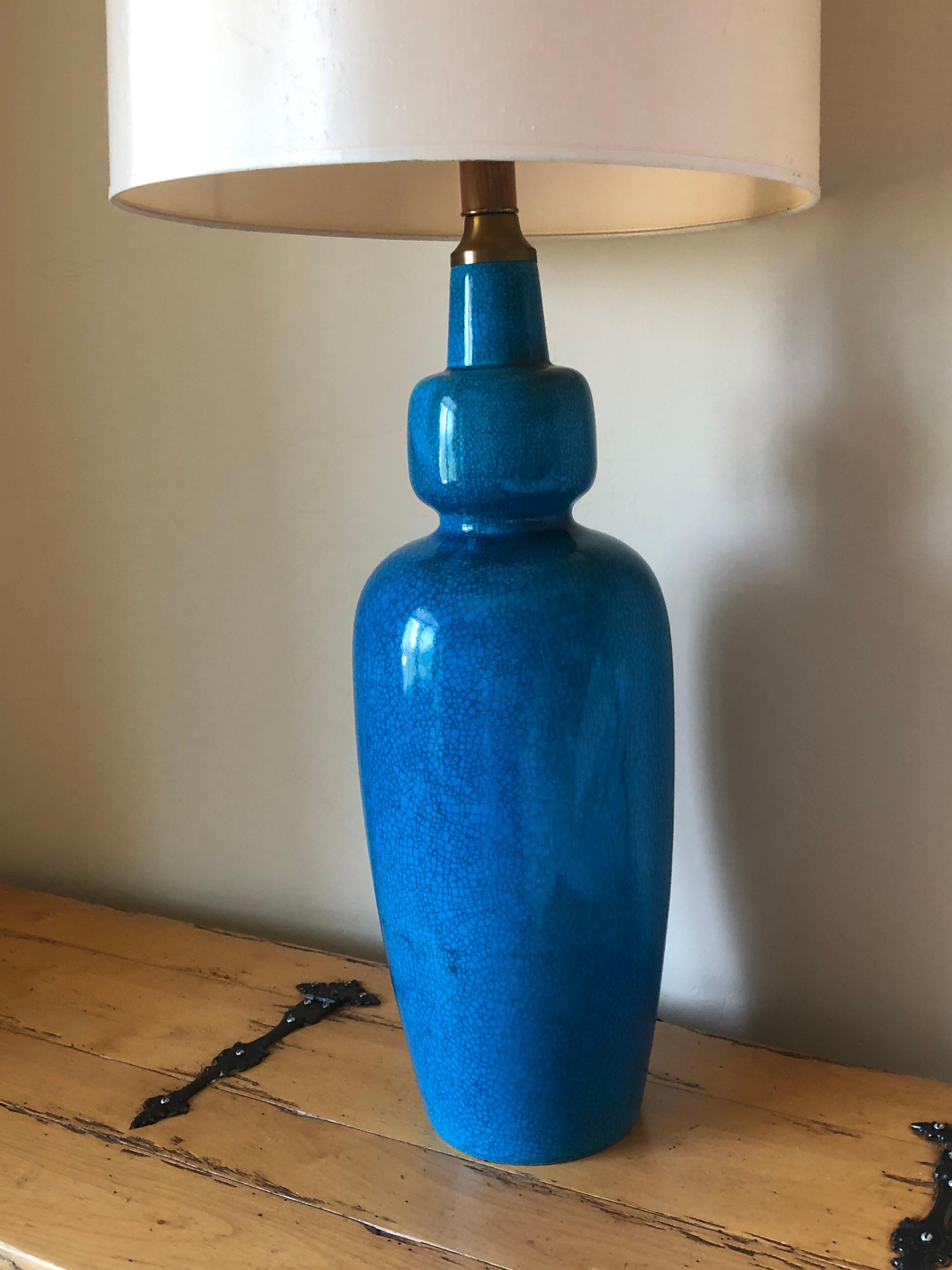 This lamp has its original shade with Persian blue turquoise velvet trim around the edge of the shade.

Stately and impressive size stands alone and makes a statement. The lamp has no base and stands an impressive 42