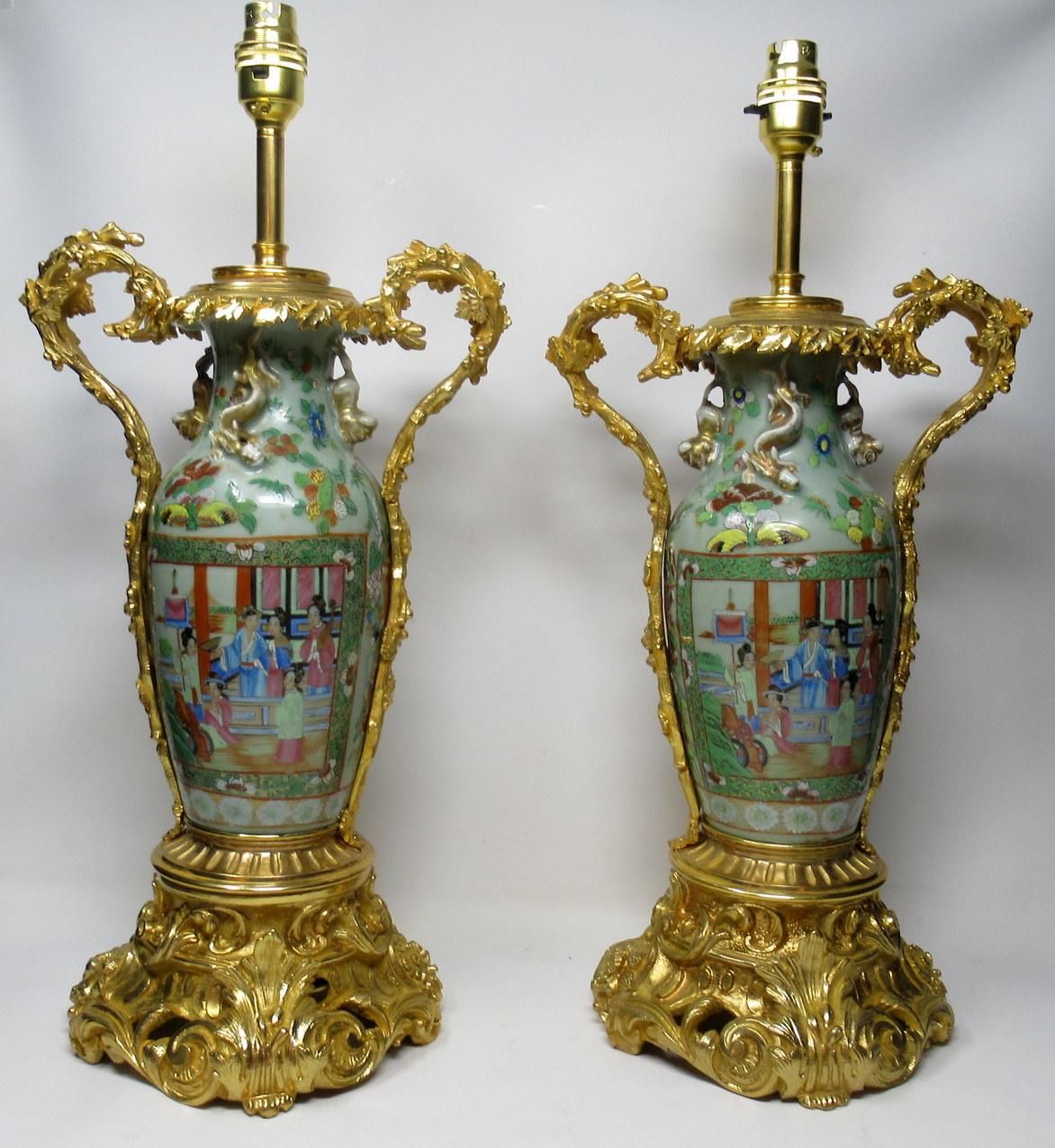 An exceptionally fine pair of cantonese hand decorated porcelain oil lamps with ornate ormolu bases now converted to electric table lamps, of good size proportions, mid-19th century.

The main outer bodies of bulbous form with hand painted panels in