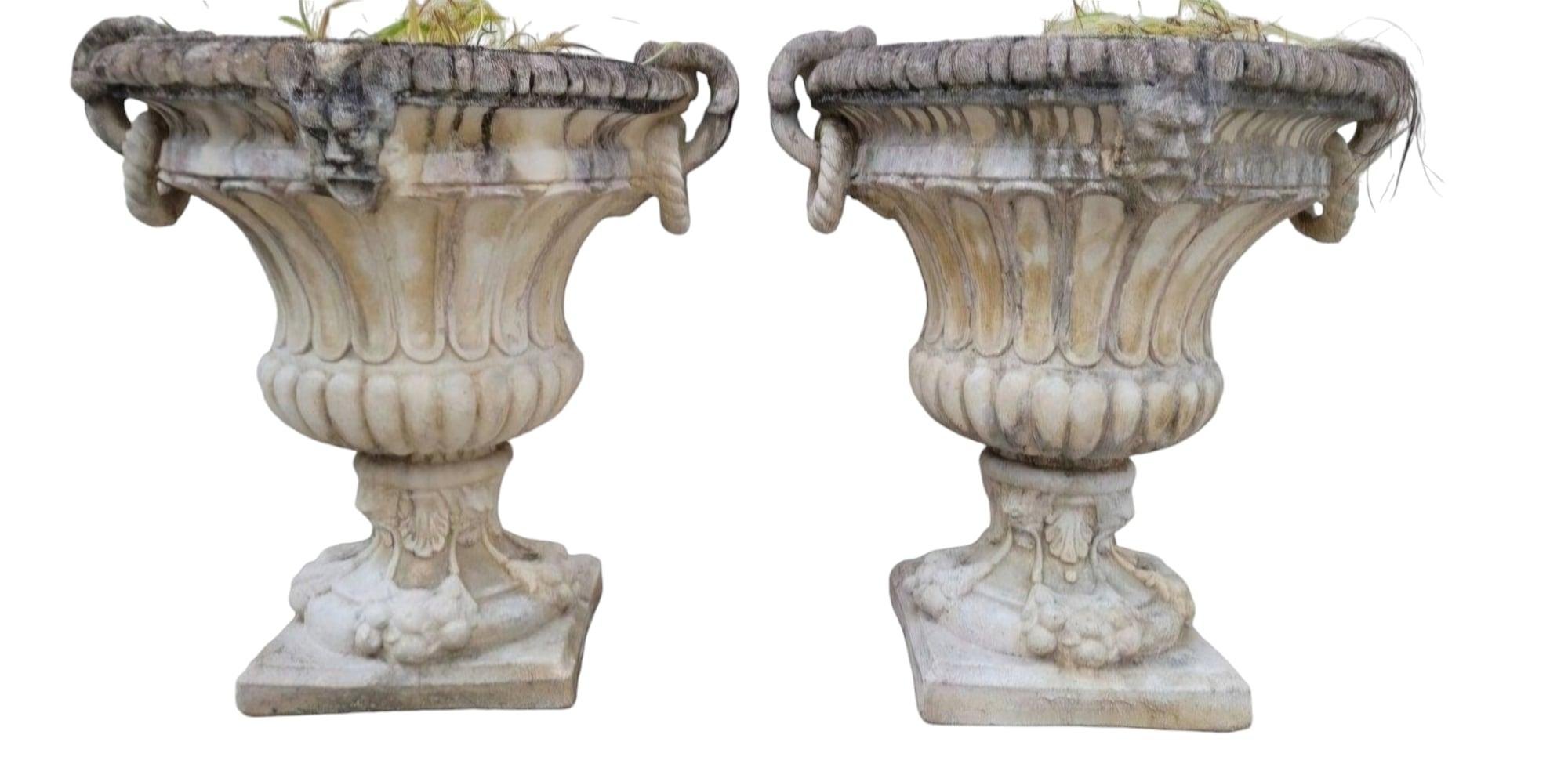 Transform your garden or interior space with our extraordinary Pair of 1950s Stone Planter Vases Richly Decorated with Faces. These stunning vases, crafted from reconstituted stone, boast exceptional quality and intricate detailing, capturing the