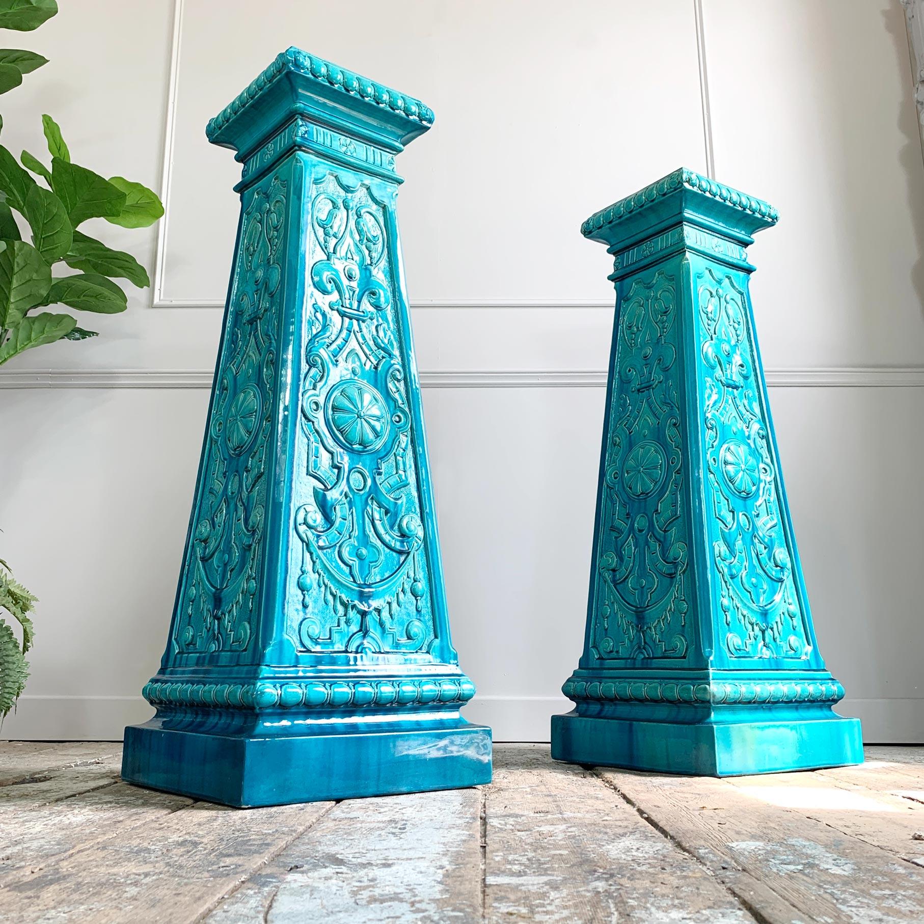 An outstandingly beautiful pair of deep turquoise jardiniere stands by the Burmantofts pottery, Leeds, England. These are in exceptional condition and highly decorated with moulded relief pattern of Art Nouveau influences. The design and shape of