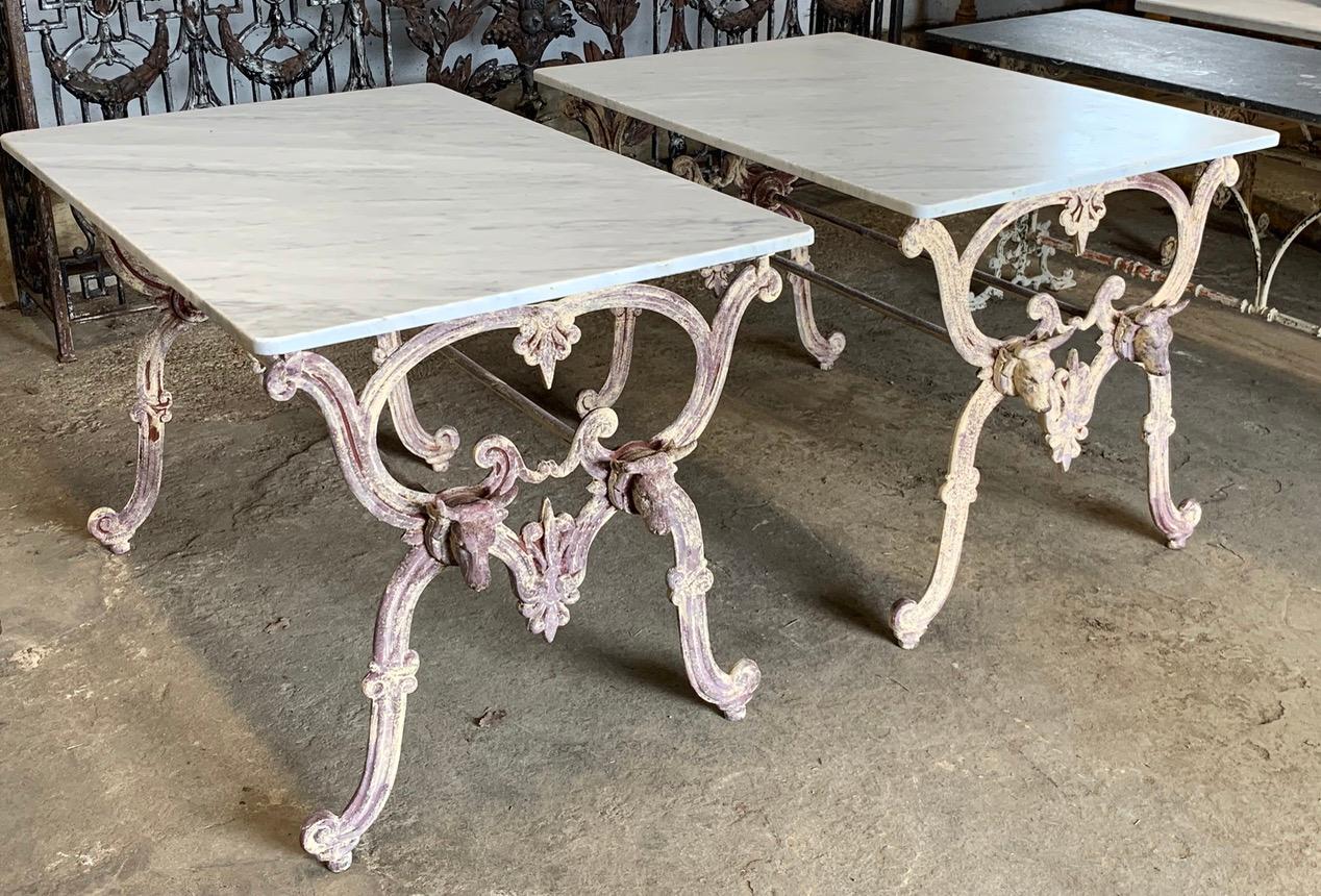 A stunning pair of late 19th century Butchers tables from France. With a cast iron bases which have layers of old paint which has been scrapped back to give it a great look. The removable tops are solid Carrara marble which are in good condition.
