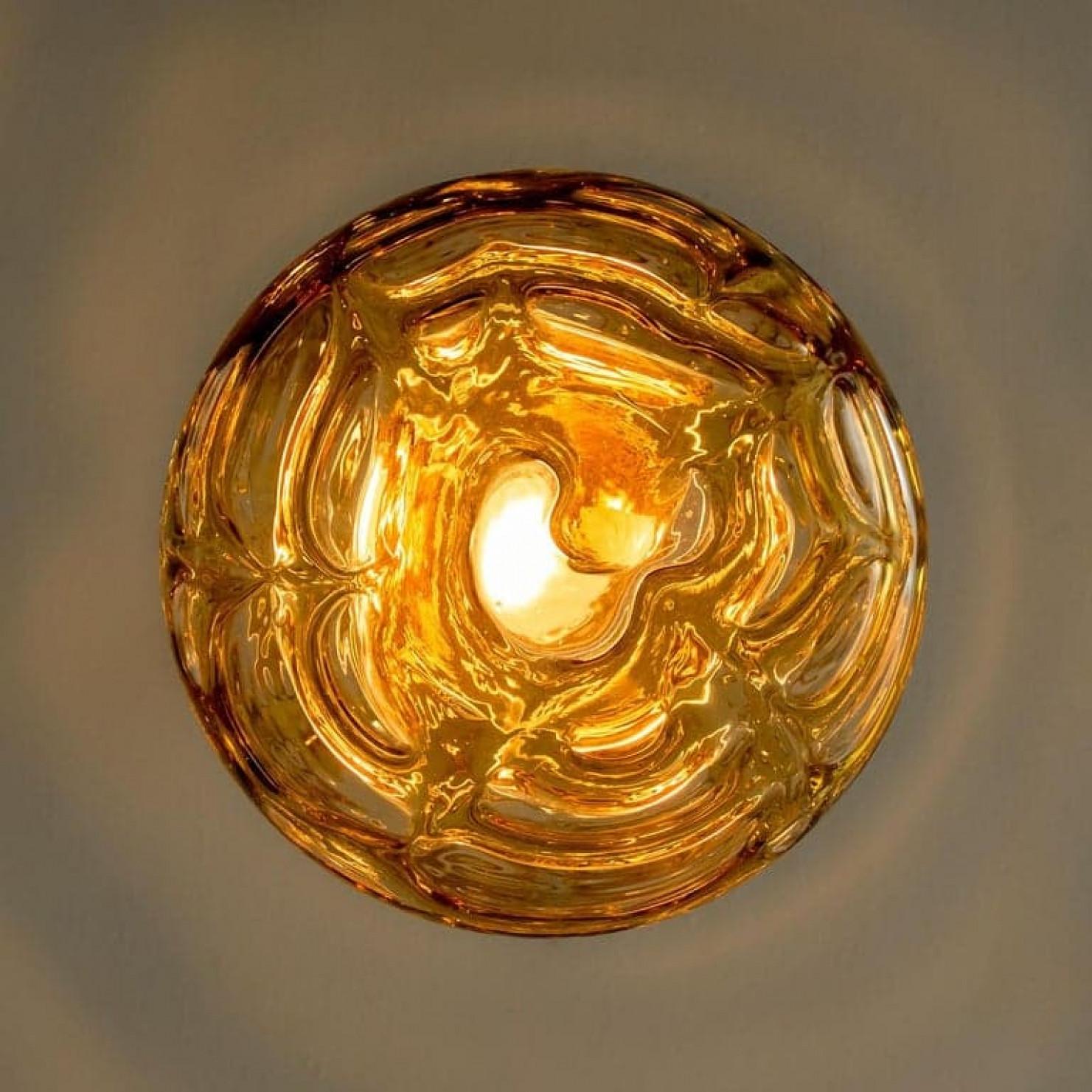 Pair of high-end XL Murano pendant lights in the style of Venini, manufactured circa 1960. Real statement pieces. Heavy quality thick Murano crystal glass shade made out of overlay glasses of clear, light amber and dark amber applied in irregular