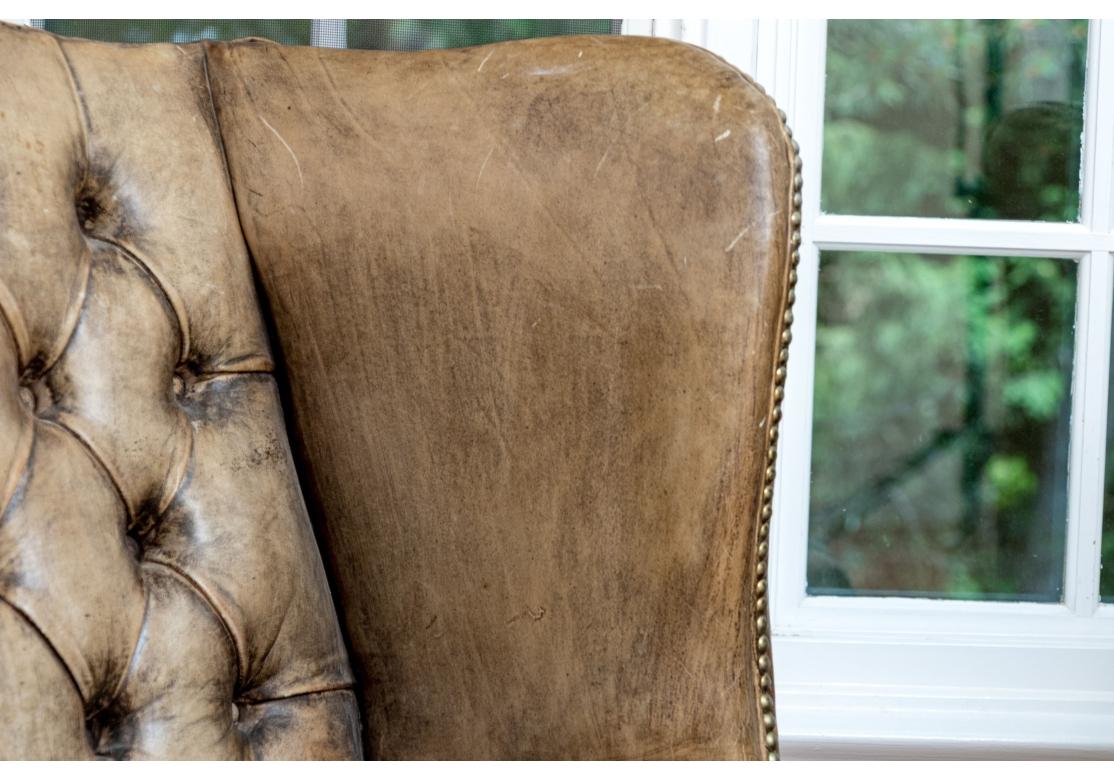 Exceptional Pair Of Antique Chippendale Style Leather Wing Chairs In Distressed Condition For Sale In Bridgeport, CT