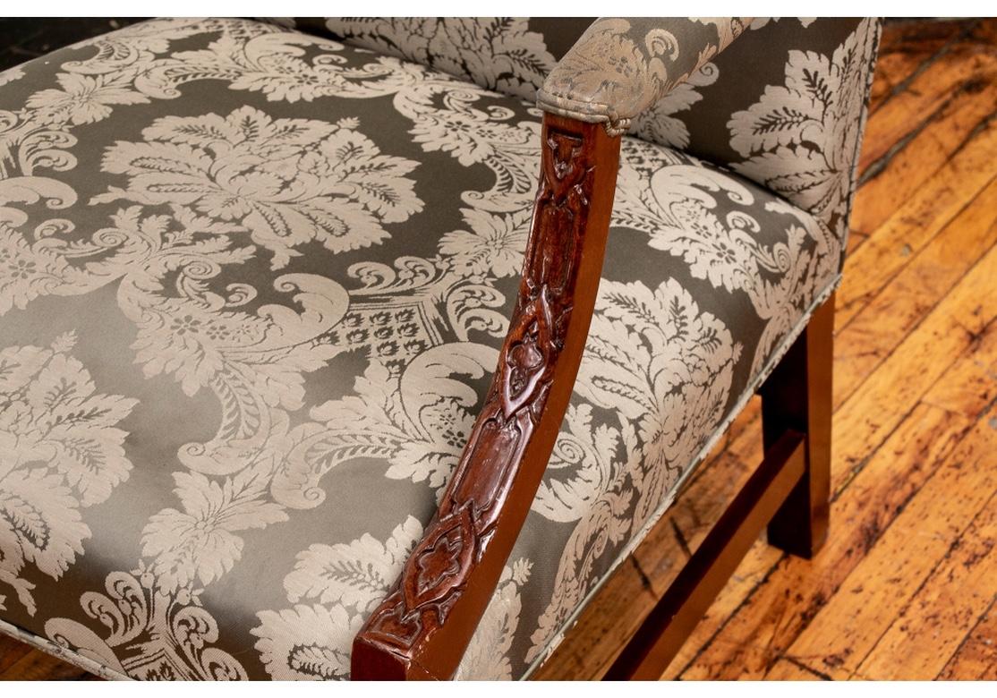 With arched backs and square seats. The arms and front legs with carved blind fretwork with geometric motifs. The square legs with a back stretcher and H-stretcher. Beautifully and newly upholstered in a Fine sage green damask fabric.
Measures: