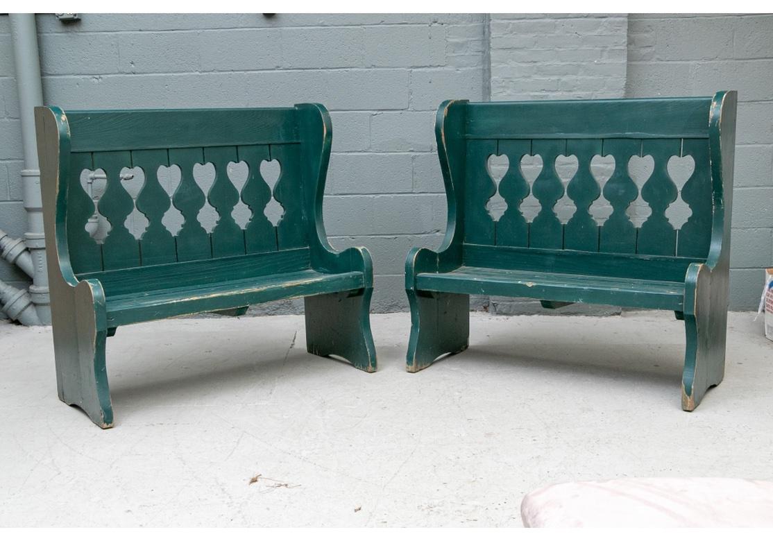 A very well made and sturdy pair of Classic American Antique Green Paint Porch Benches. In a Moss Green Paint and with Baluster Cut-out backs, slat seats and wing Chair type sides. 
Each Bench measures 44” wide by 18.75” deep by 42.25” high. Seat