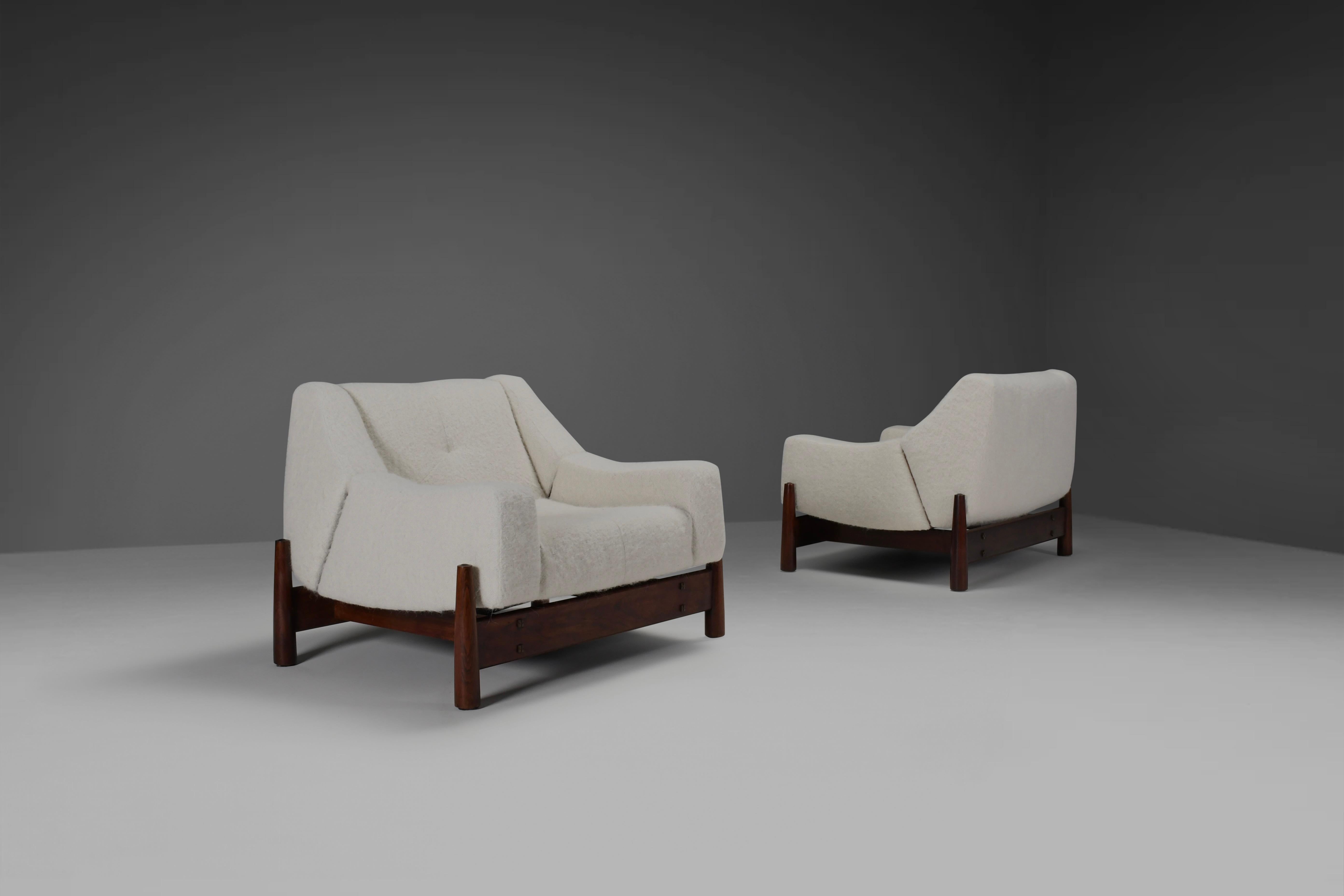 Exceptional pair of restored Brazilian lounge chairs in excellent condition.

Manufactured by Móveis Cimo, Brazil in the late 1950s.

The chairs feature an organic shaped seat and backrest that seams to float over the wooden frame. 
We reupholstered