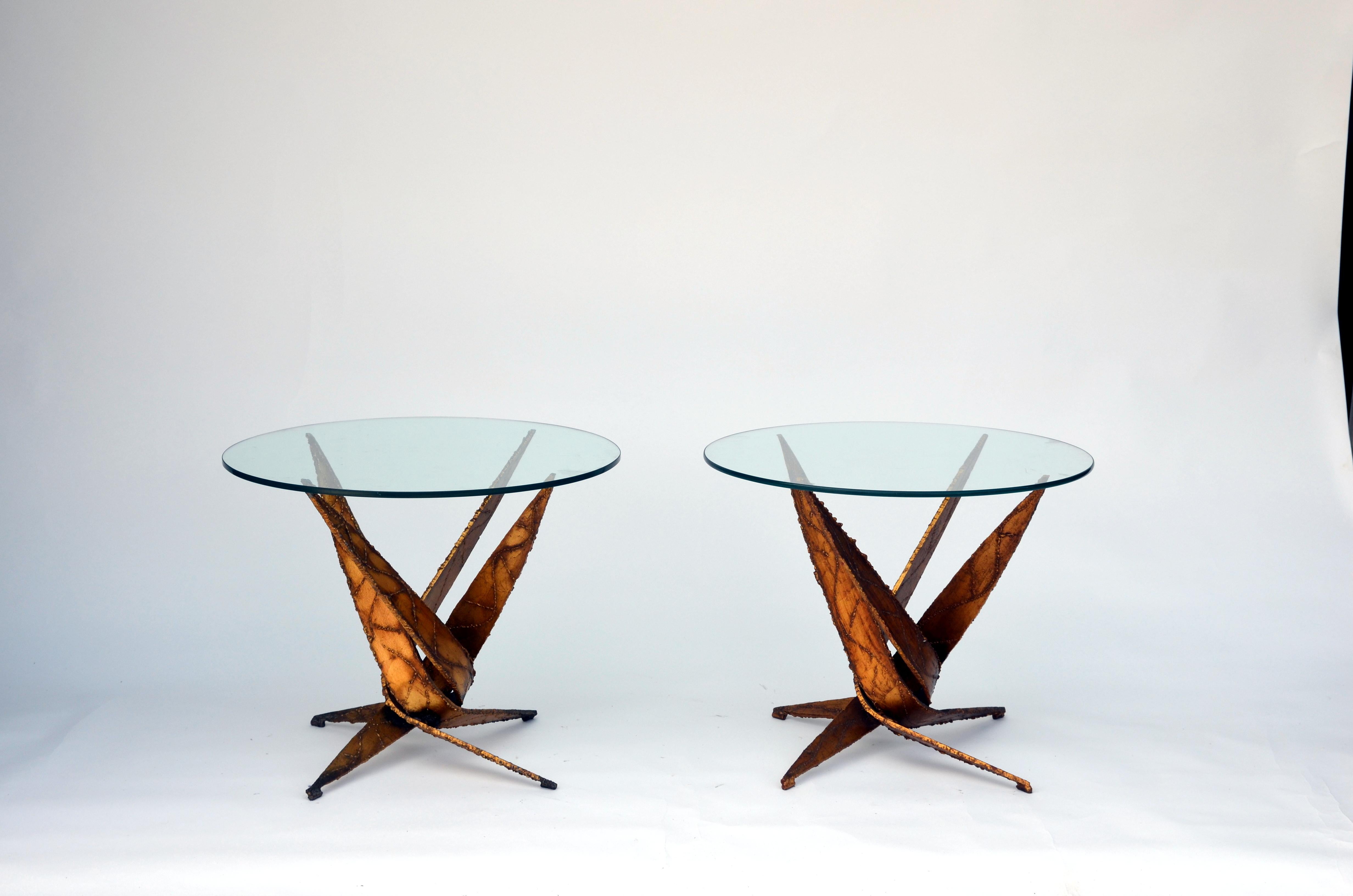 Exceptional pair of brutalist side or end tables by Silas Seandel. Rare as a pair. Torch-cut acid and heat treated steel bases with glass tops.

Silas Seandel was born in New York City, August 11, 1937. He studied sculpture and economics at the