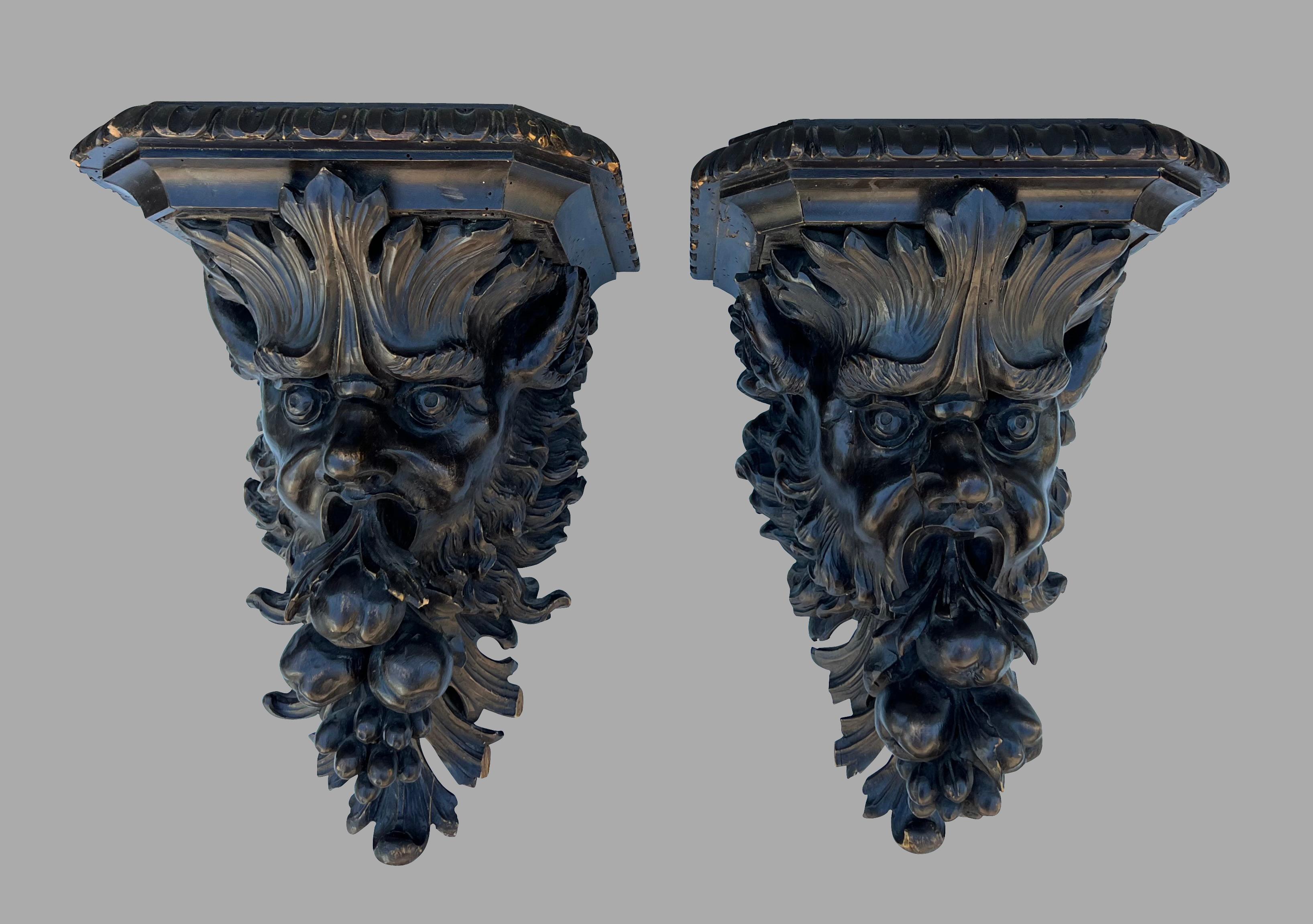 An exceptional highly carved pair of walnut wall brackets consisting of dramatic well-carved faces of mythological creatures with wide eyes, opened mouths and wild flowing hair. Substantial in scale, these are truly dramatic. Brackets such as this