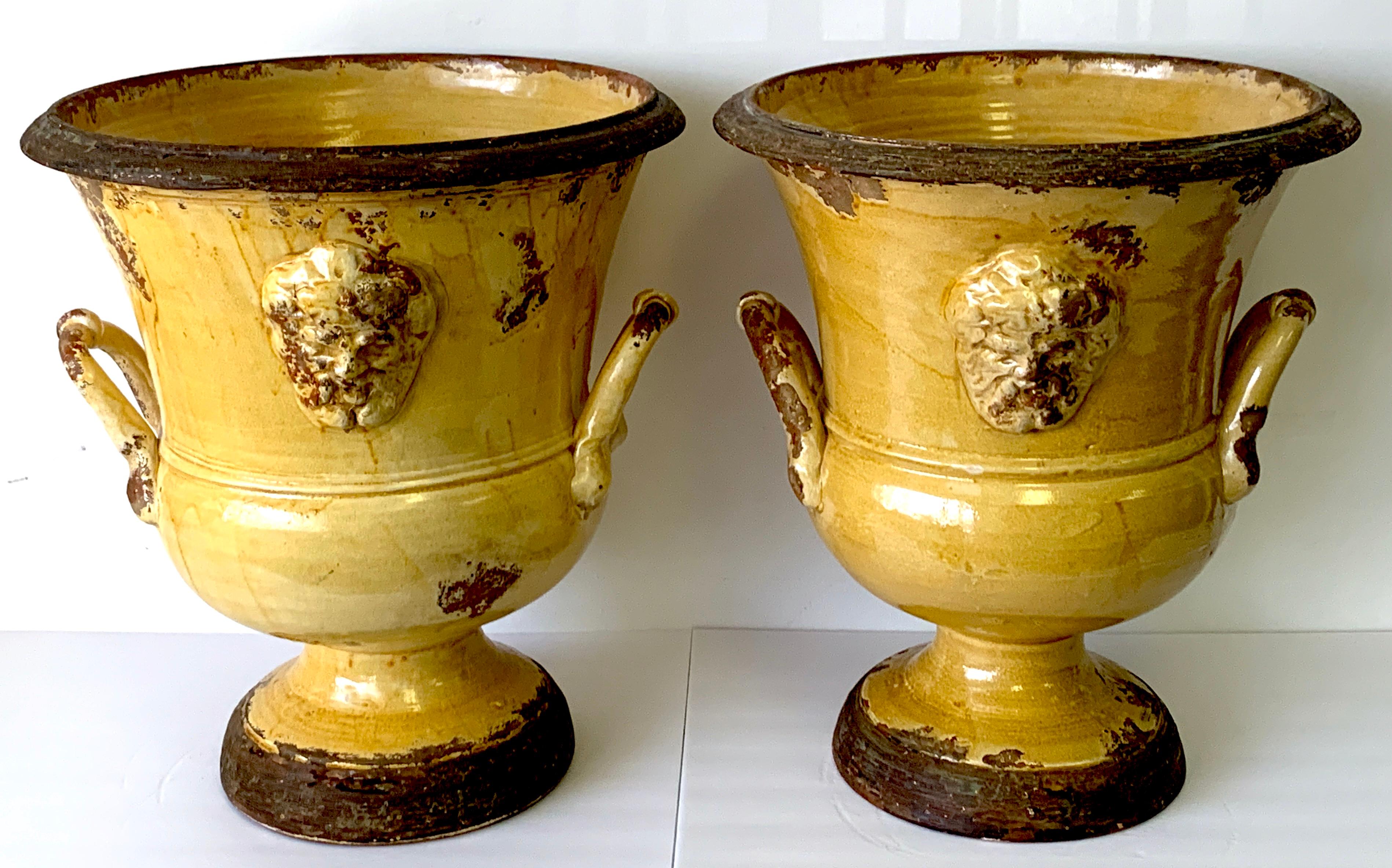 Exceptional pair of Italian Anduze / yellow glazed terracotta medallion urns
Each one of campana form with medallion front and backs, and twin applied handles. Beautiful inconsistent glaze, ready to place indoors or outside.
The diameter of the base