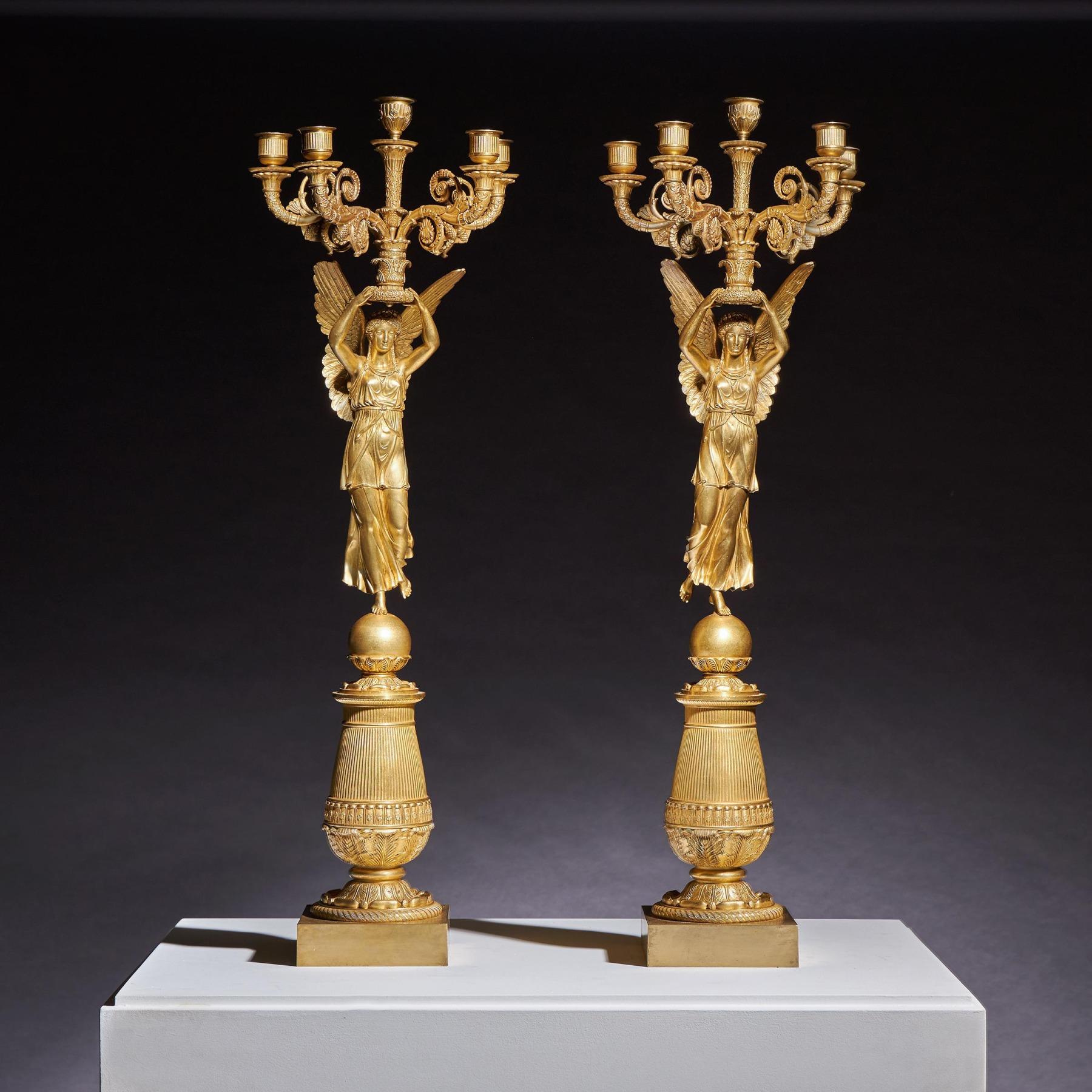 A pair of exceptionally elegant and important late Empire five-light figural candelabra ‘A la Victoire’ in gilt-bronze, attributed to Pierre-Philippe Thomire, after a design by Charles Percier. Imposing size at 81cm in height.

French Paris