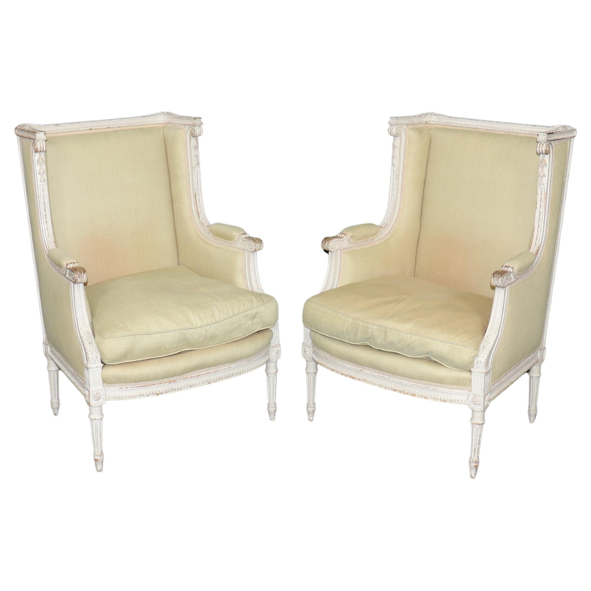Exceptional pair of French Louis XVI Style Creme Painted Bergere Chairs For Sale