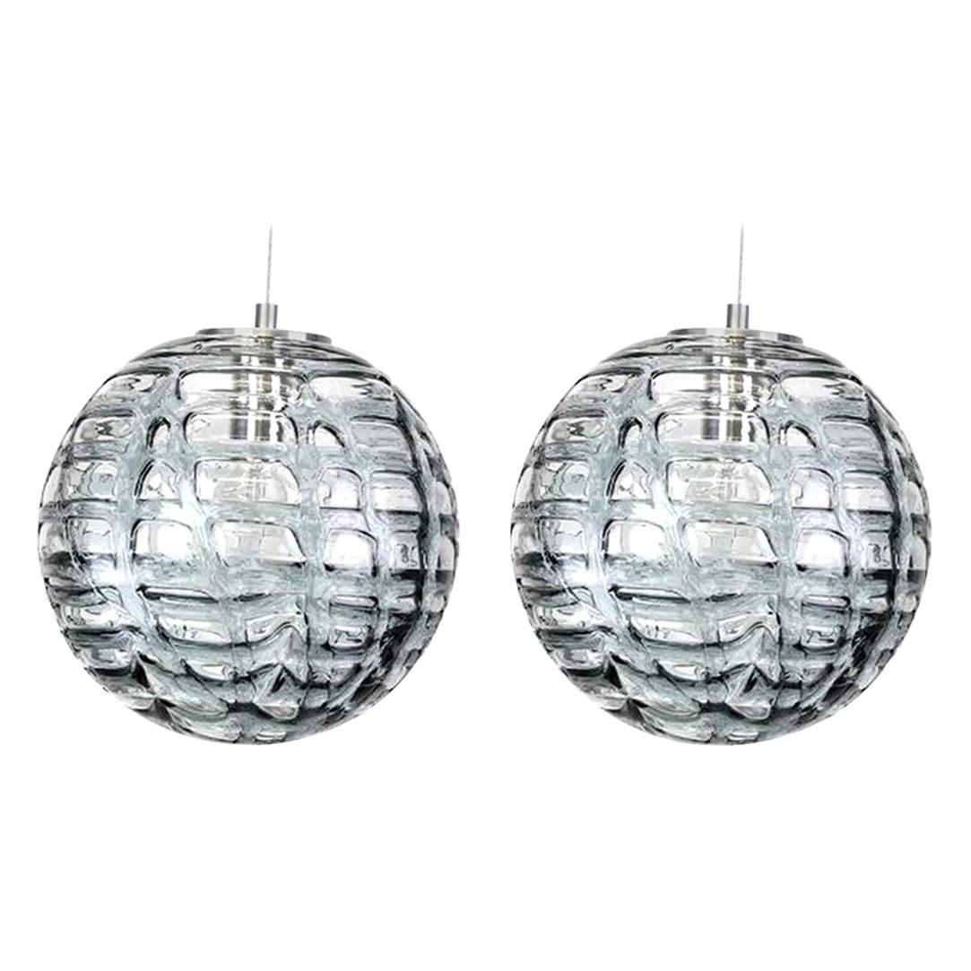 Pair of high-end Murano pendant lights in the style of Venini, manufactured, circa 1960. Real statement pieces. Heavy quality thick Murano crystal glass shade made out of overlay glasses of clear, light grey and dark grey applied in irregular