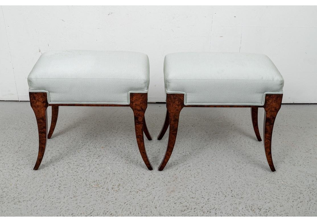 Very well made and striking Pair of Klismos Benches in Burl. Require re-upholstering. Fine construction in burled wood with classic tapering square splayed klismos legs. Custom upholstered by Switzer in a soft green silk. William Switzerland tags