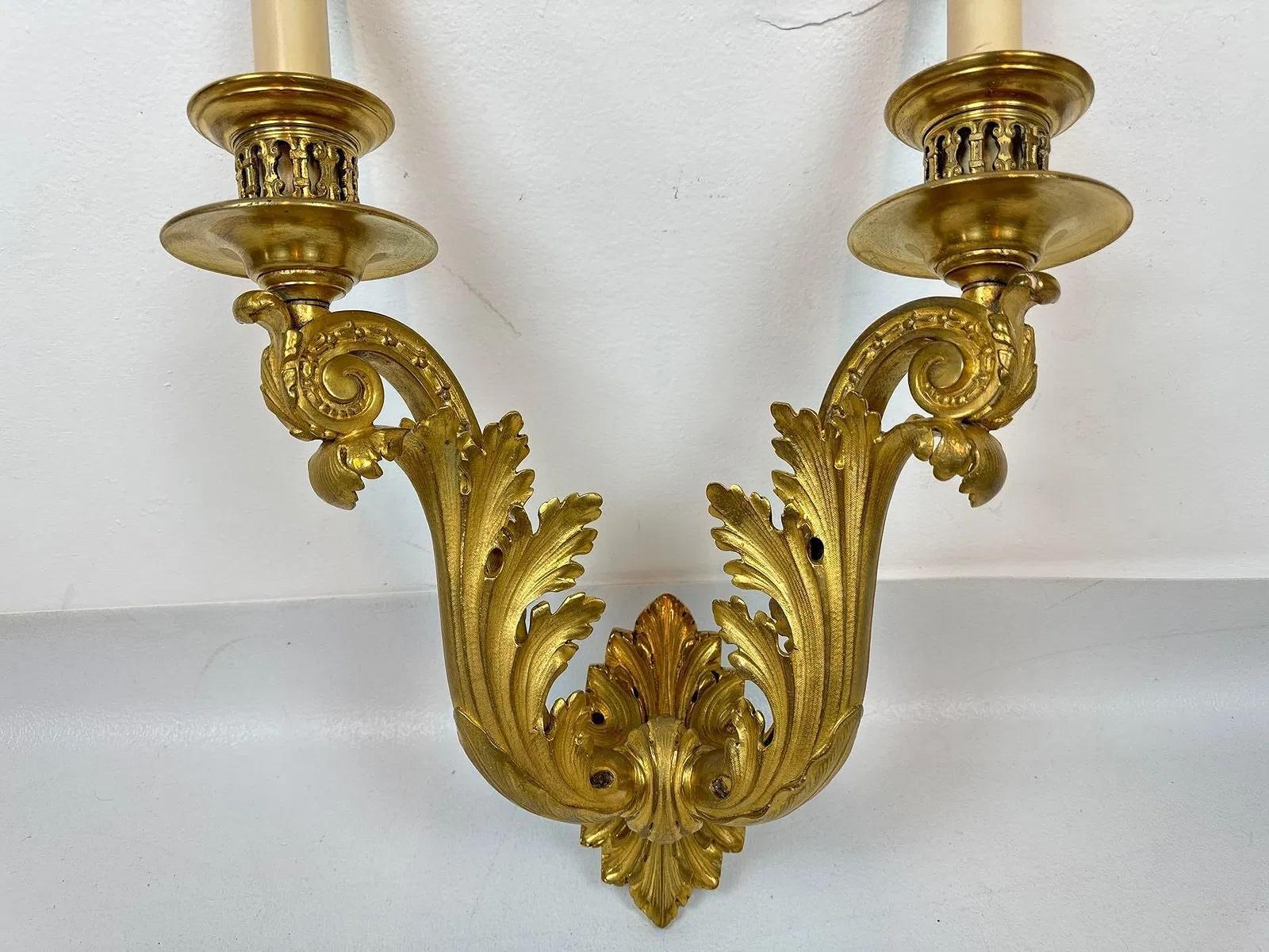 Pair of rare Gilt Bronze Laurel sconces by Edward F. Caldwell & Co., circa 1910-1920
Elegant design and detailed cast - Each with two light supports, above superbly carved scrolls , hard wired and electrified. 

Unusual and rare neoclassical design