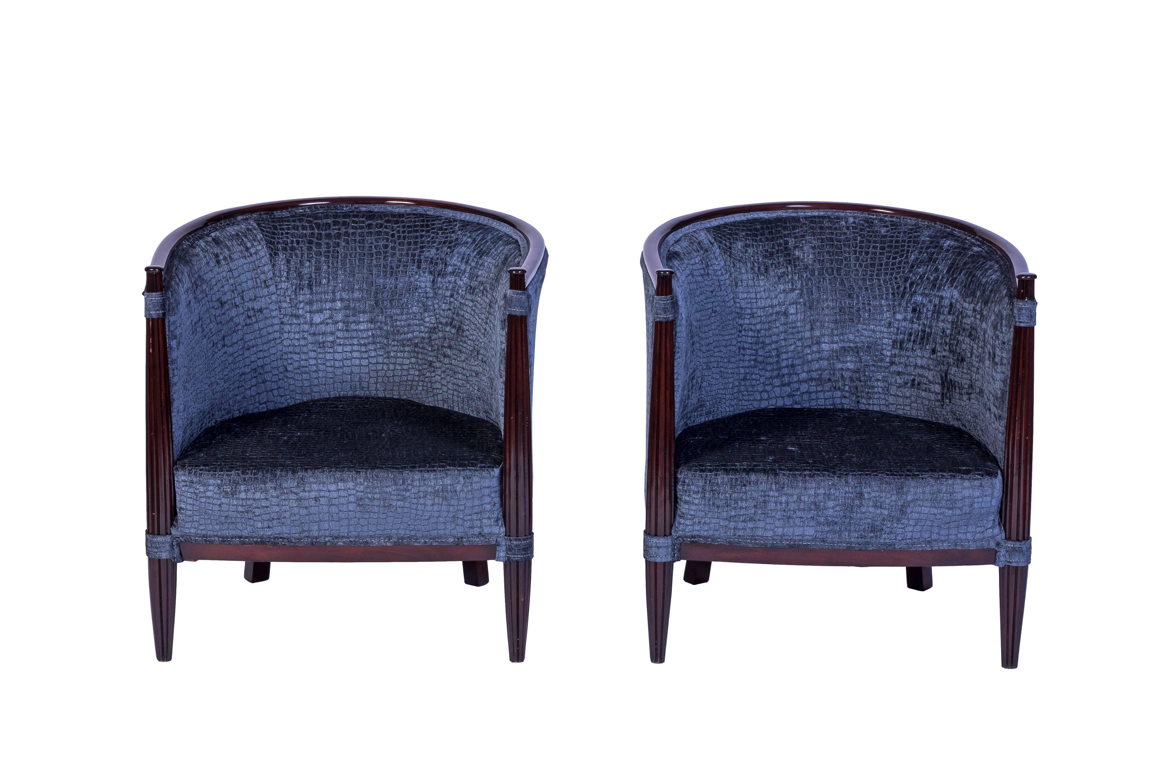 Exceptional pair of solid red mahogany club chairs in the style of Paul Follot are the perfect example of beautiful classic Art Deco. They have been newly refinish and reupholstered.