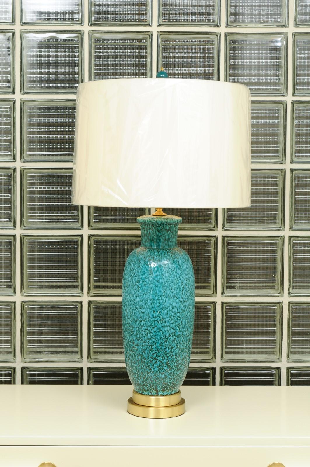 These magnificent lamps have been professionally restored and are shipped as photographed and described, complete with new shades, harps and finials.

A fabulous pair of large-scale vintage ceramic and brass lamps, circa 1960. The Turquoise color