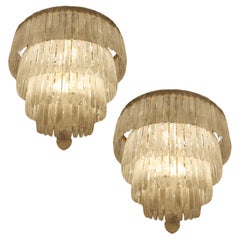 Exceptional pair of rock crystal chandeliers with four tiers sixty light 