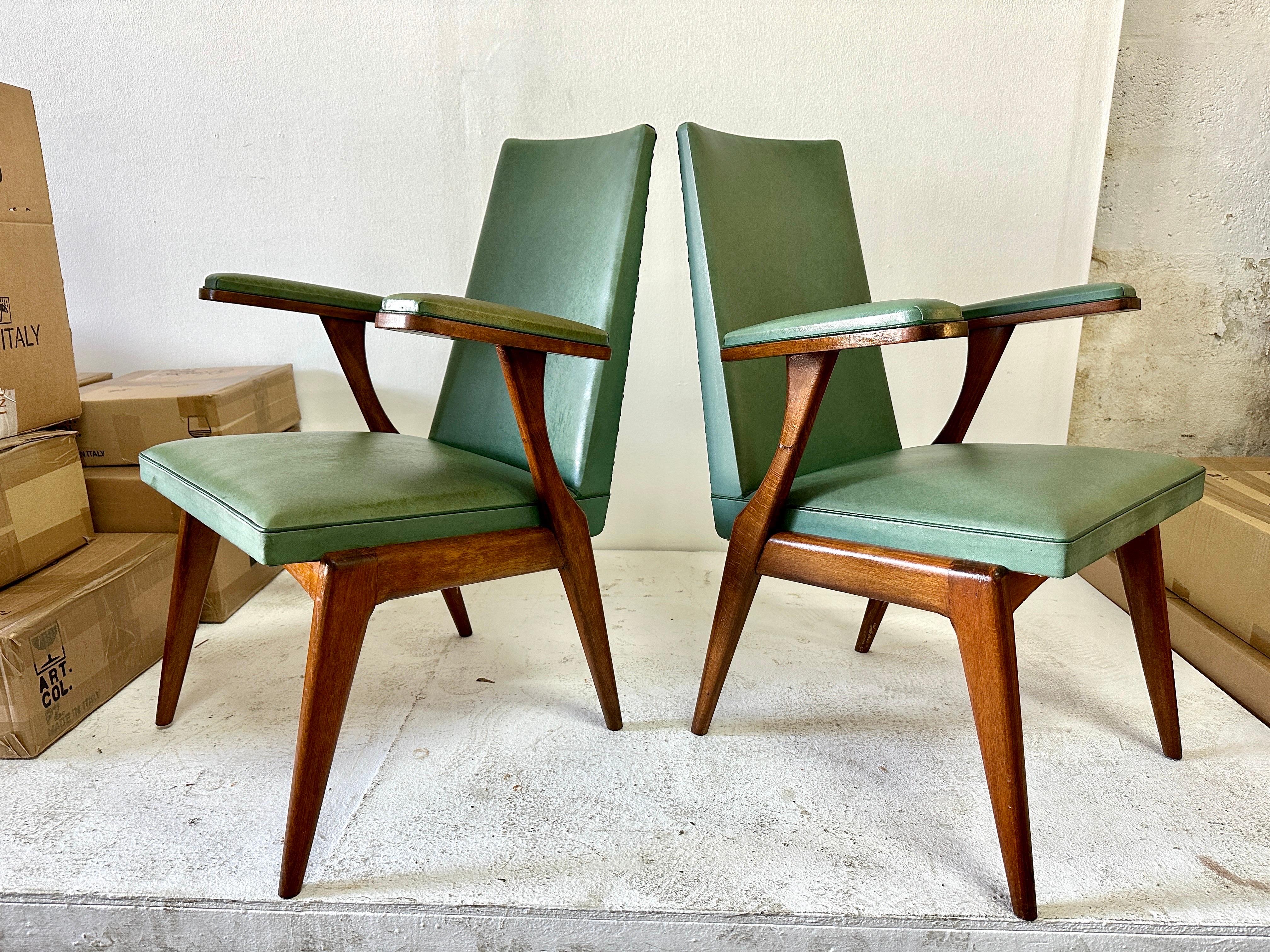 Very sleek and hard to find, this is a pair of floating arm-rest chairs with original faux leather green upholstery (original vintage condition). They will add uniqueness to any design - can be used as host/hostess chairs, side chairs and more!