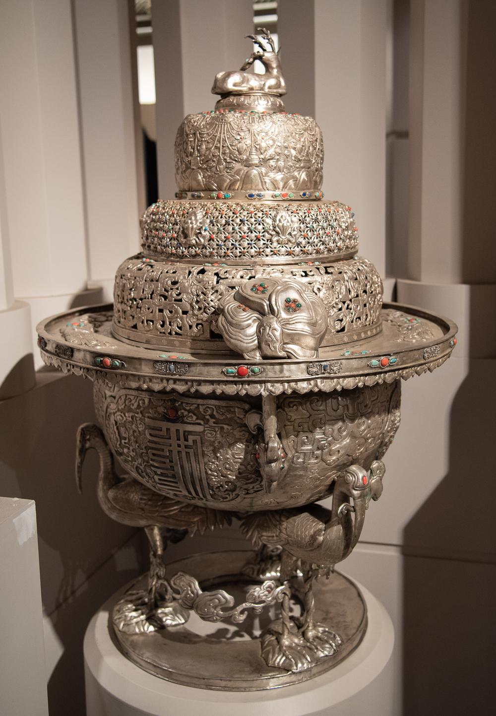 An exceptional pair of Sino-Mongolian silvered copper incense burners embellished with carved Jade plaques and Thodarpana mani1 Cabochons of Turquoise, Coral, Gold-Stone and Lapis Lazuli. The stepped circular bodies of each are composed of a pierced