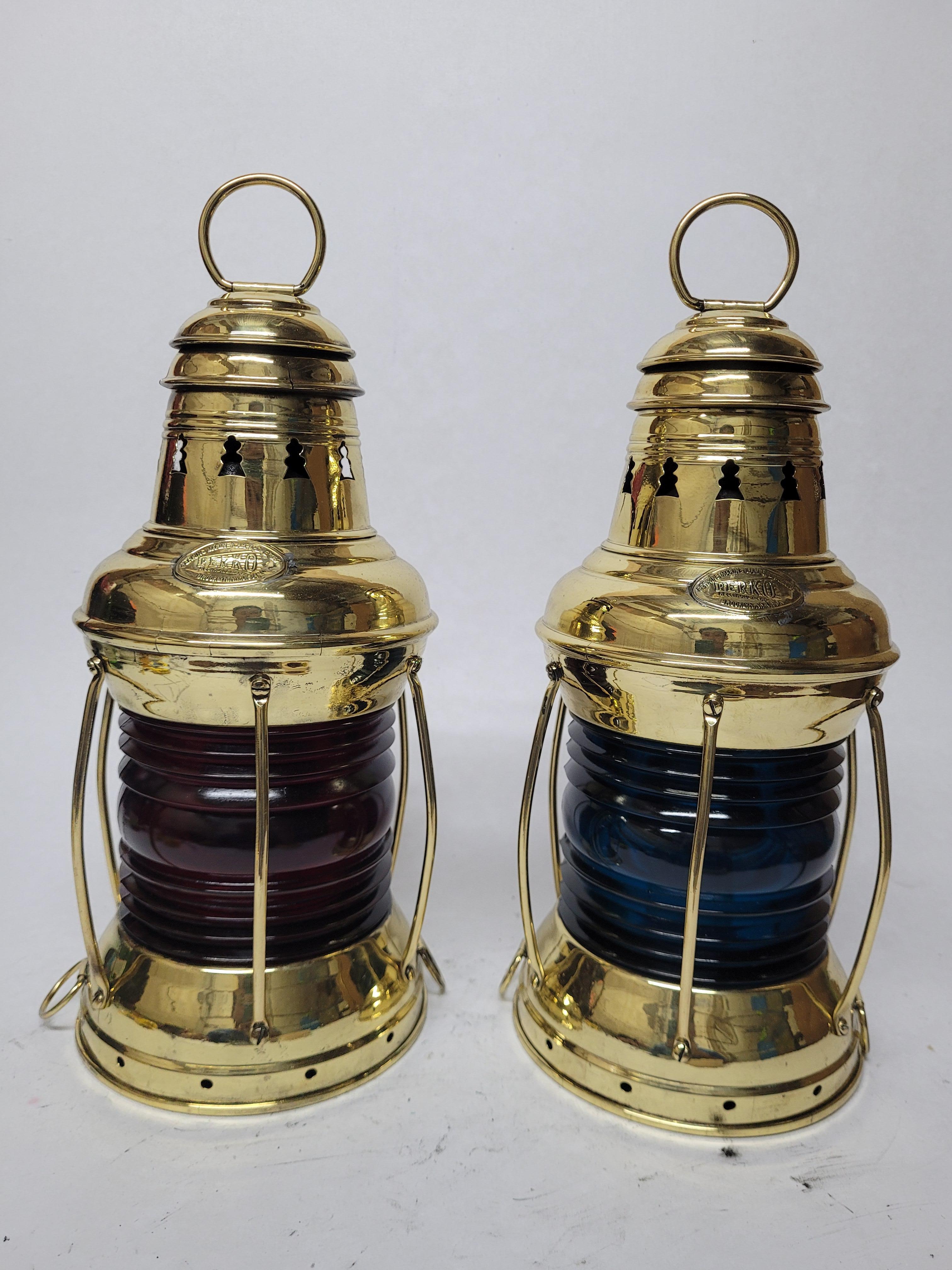 Pair of meticulously polished and lacqured marine lanterns by Perkins Marine Lamp Corporation of Brooklyn New York. Fitted with beautiful blue and red lenses. Vented tops with carry rings. Choice marine antiques. Circa 1935. American

Weight: 3.47